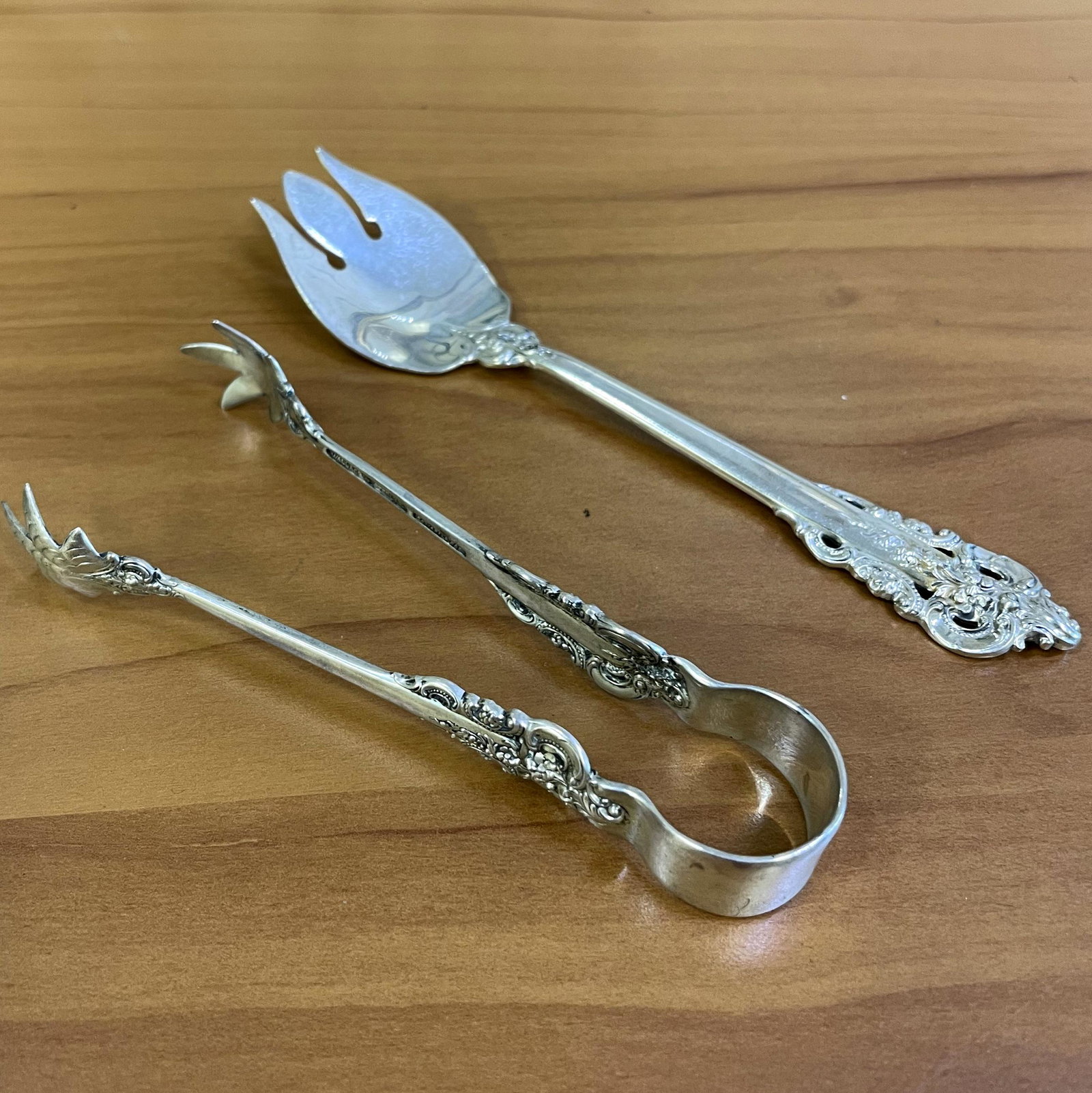 Wallace Grande Baroque Sterling Silver Flatware set of: .925 Sterling Silver flatware. One ice cream fork (5.5") and one rare sugar tongs (4.5"). 64.3g