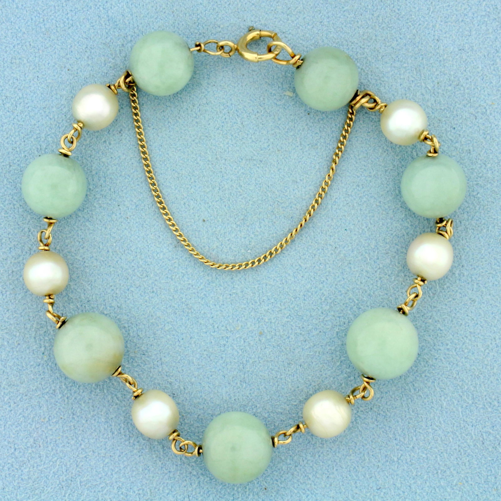 Jade and Pearl Ball Bead Bracelet in 14K Yellow Gold: In 14K Yellow Gold. Contains seven high quality natural 10.8mm Jade beads with uniform light green color. Also contains six 7mm cultured Pearls with high luster. 7 inches long. With safety chain. 18.8