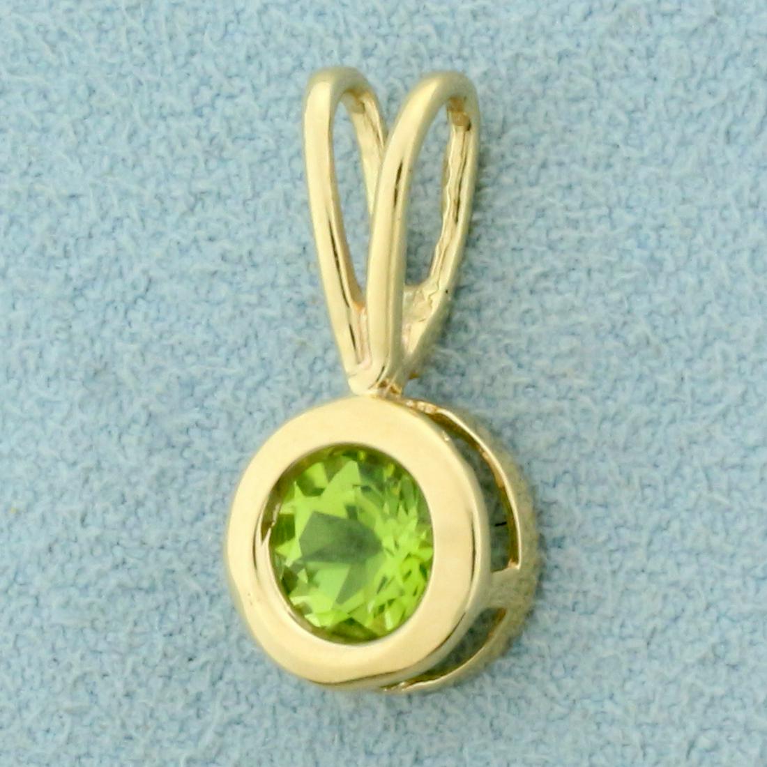 1ct Peridot Pendant in 14K Yellow Gold: In 14K Yellow Gold. Contains one high quality natural 1ct Peridot gemstone with intense lime green color and excellent clarity. 3/4 inch long, 3/8 inch wide. 1.2g.