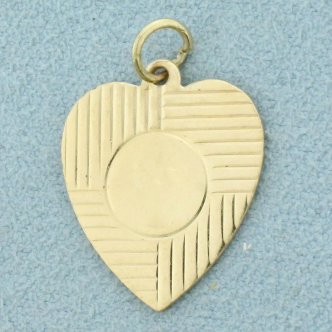Engravable Heart Pendant in 14K Yellow Gold: In 14K Yellow Gold. 1 inch long with bale, 5/8 inch wide. Back is blank so can engrave name or date. 2.0g.