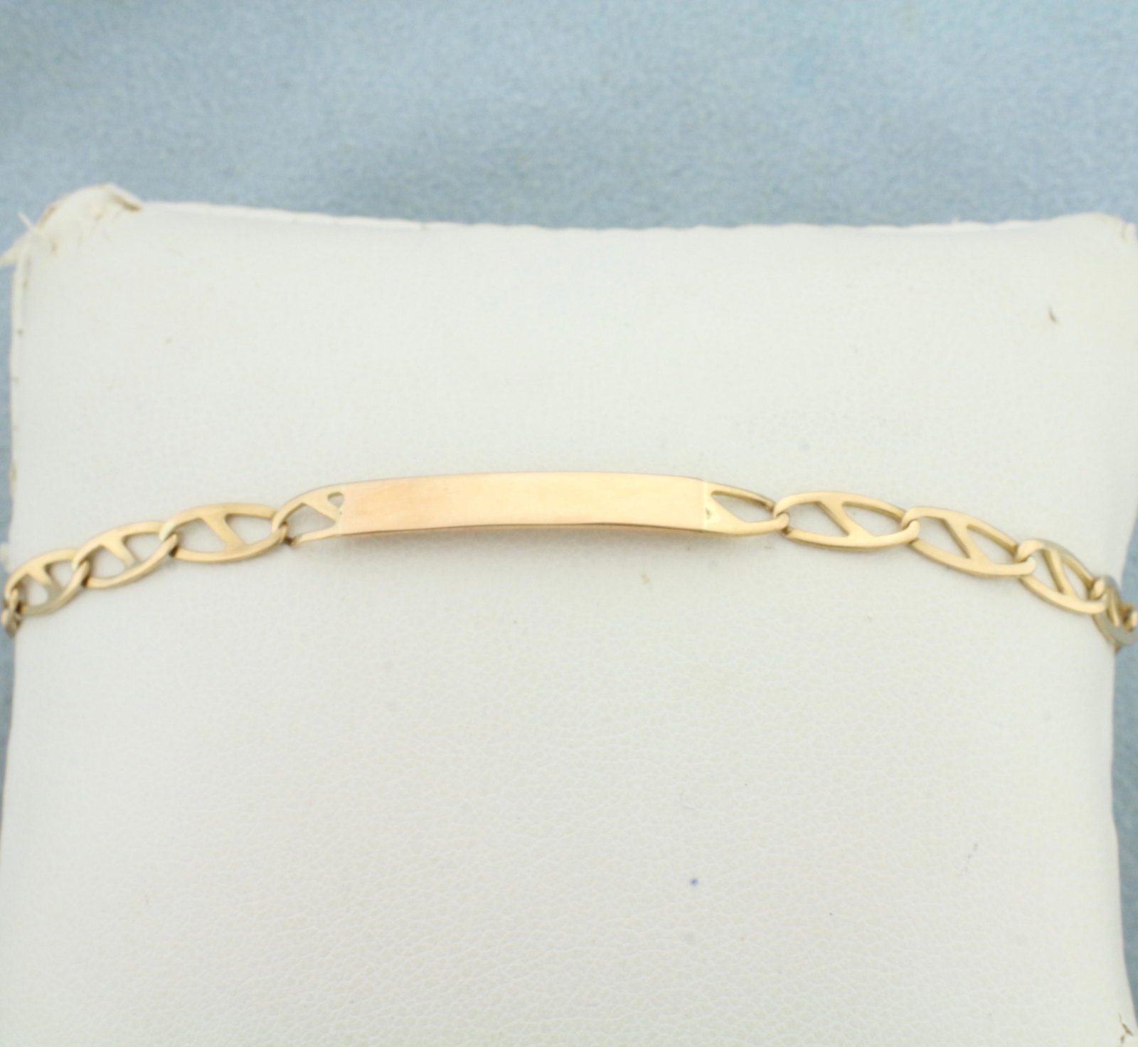 Engravable ID Bracelet in 10K Yellow Gold: In 10K Yellow Gold. Engravable portion is 7/8 inch wide and 4.2mm tall. Lobster clasp. 7 1/4 inches long, 4.2mm wide. 3.5g.