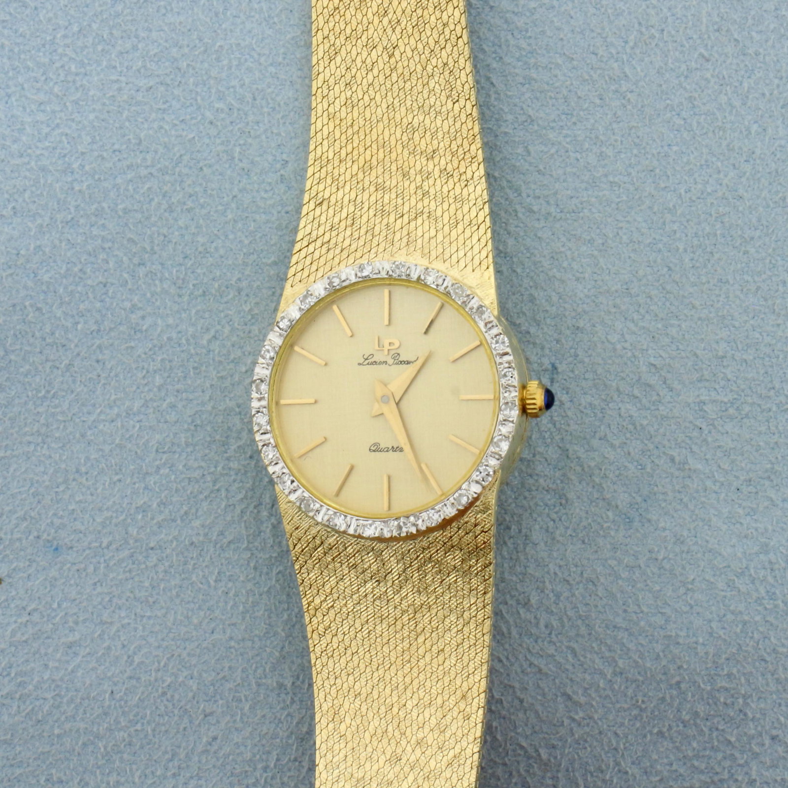 Lucien Piccard Diamond womens Watch in Solid 14K Yellow: Case and Band in Solid 14K Yellow Gold. Quartz movement runs great, new battery. Watch in excellent condition, minimal scratching on crystal and band. Case is 23mm. Sapphire gemstone in crown. Also co