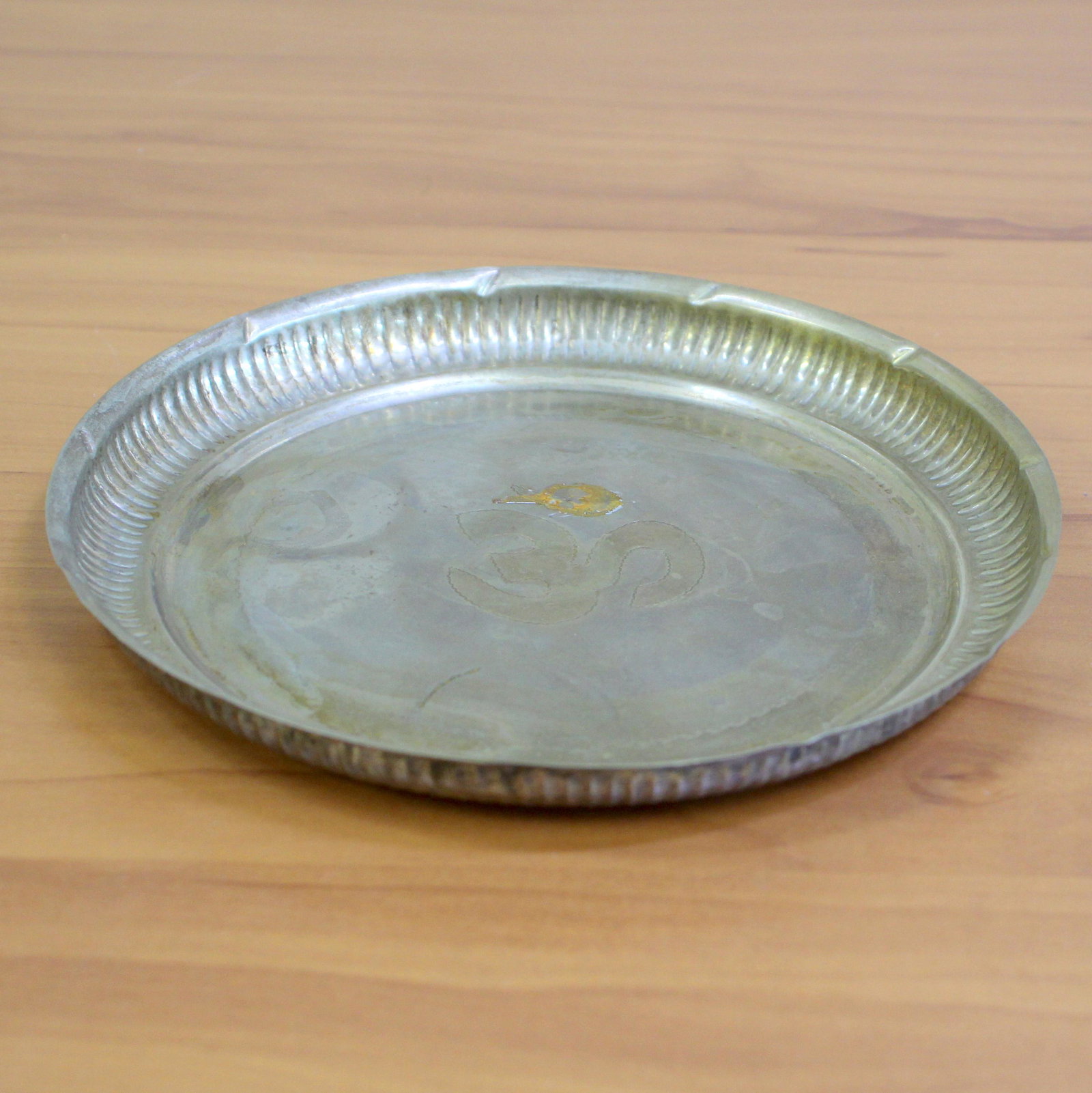 Antique Sterling Silver Cigar Ash Tray: In Sterling Silver. Plate with unique design engraved in the center. 7 1/2 inches wide. Some discoloring, indicative of age, probably can be buffed out if desired. 112.3g.