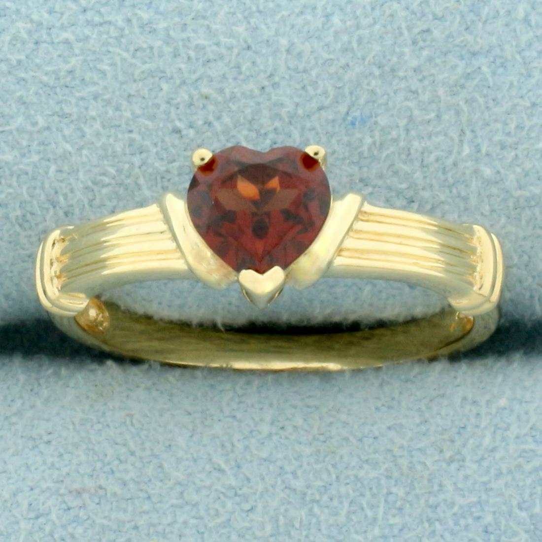 Garnet Heart Ring in 10K Yellow Gold: In 10K Yellow Gold. Contains one high quality natural 6mm heart shape Garnet gemstone with intense color and excellent clarity. Size 7 1/4. 1.5g.