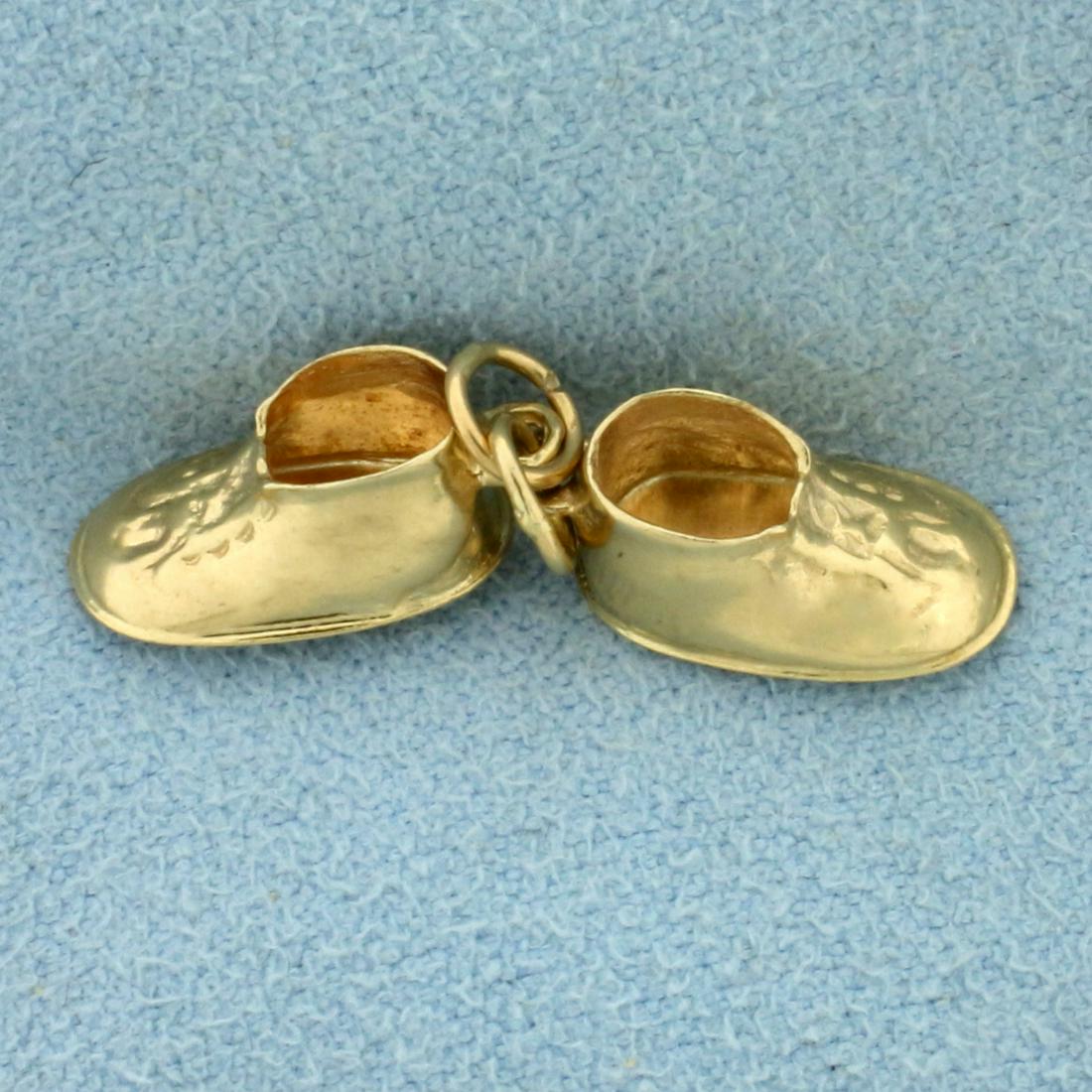 Baby Shoes Charm in 14K Yellow Gold: In 14K Yellow Gold. Each shoe 1/2 inch long. 1.7g