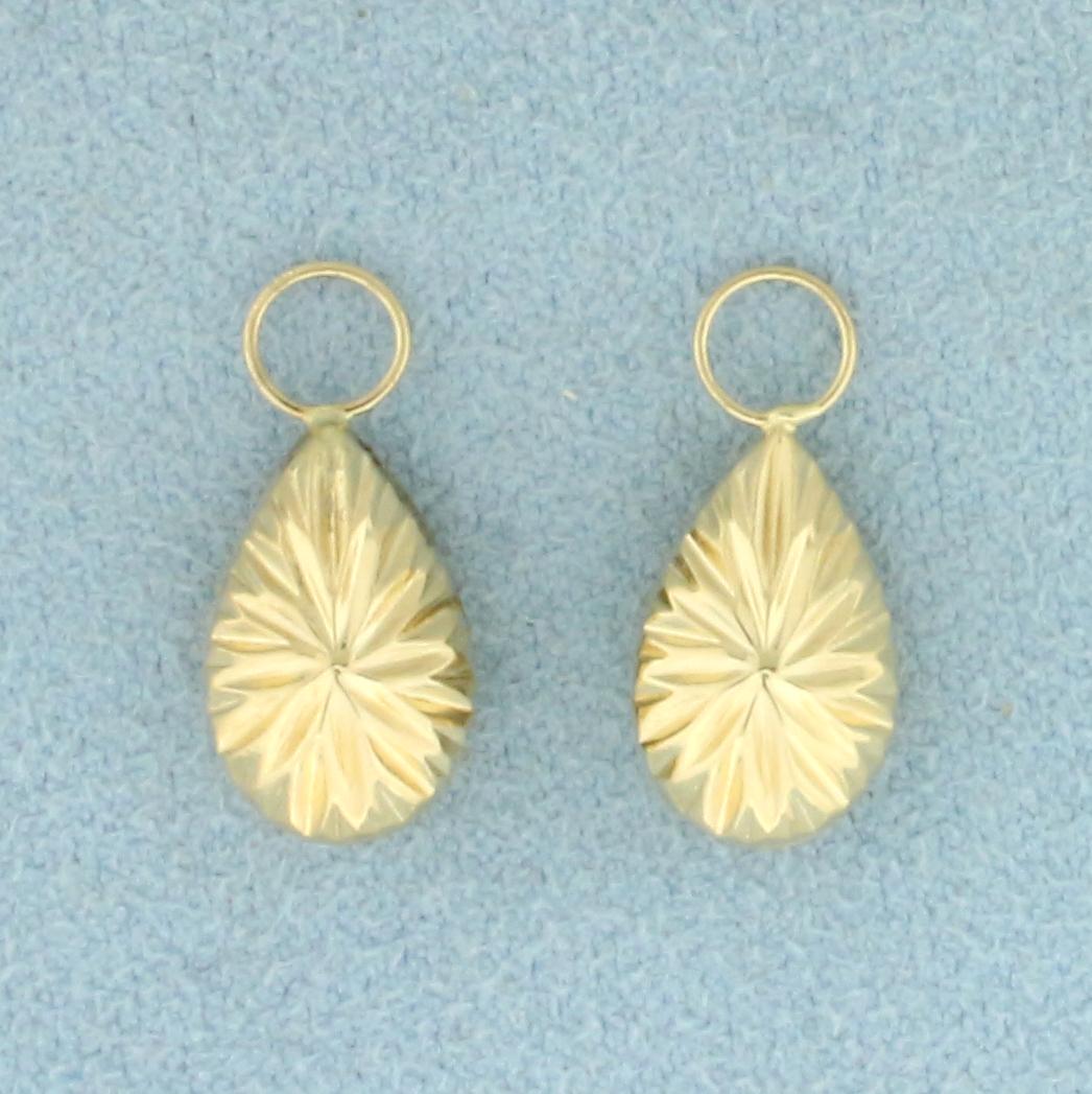 Hoop Earing Enhancer Drops in 14k Yellow Gold: In 14k yellow gold. Can accommodate up to 3.5mm hoop earrings. 3/4 inch long. .7g.