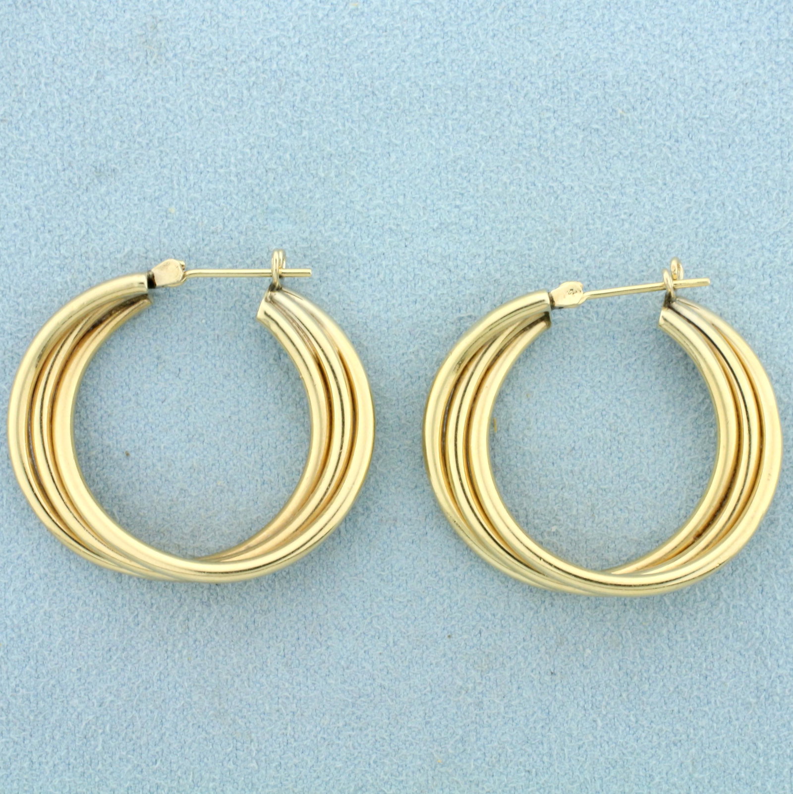 Twisting Hoop Earrings in 14K Yellow Gold: In 14K Yellow Gold. 1 1/4 inch long, 6.5mm thick. 5.9g.