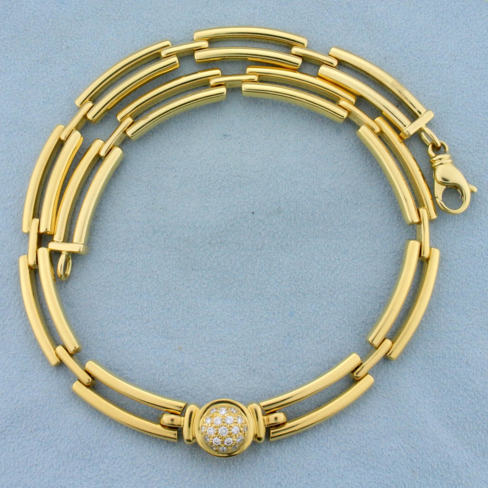 Movado Designer 1/2ct TW Diamond Choker Necklace in 18K: In 18K Yellow Gold. Contains nineteen high quality diamonds ranging from .02ct to .04cts each, VS clarity/G color. 16 inches long. Links are 8.8mm wide. Lobster clasp. 67.4g.