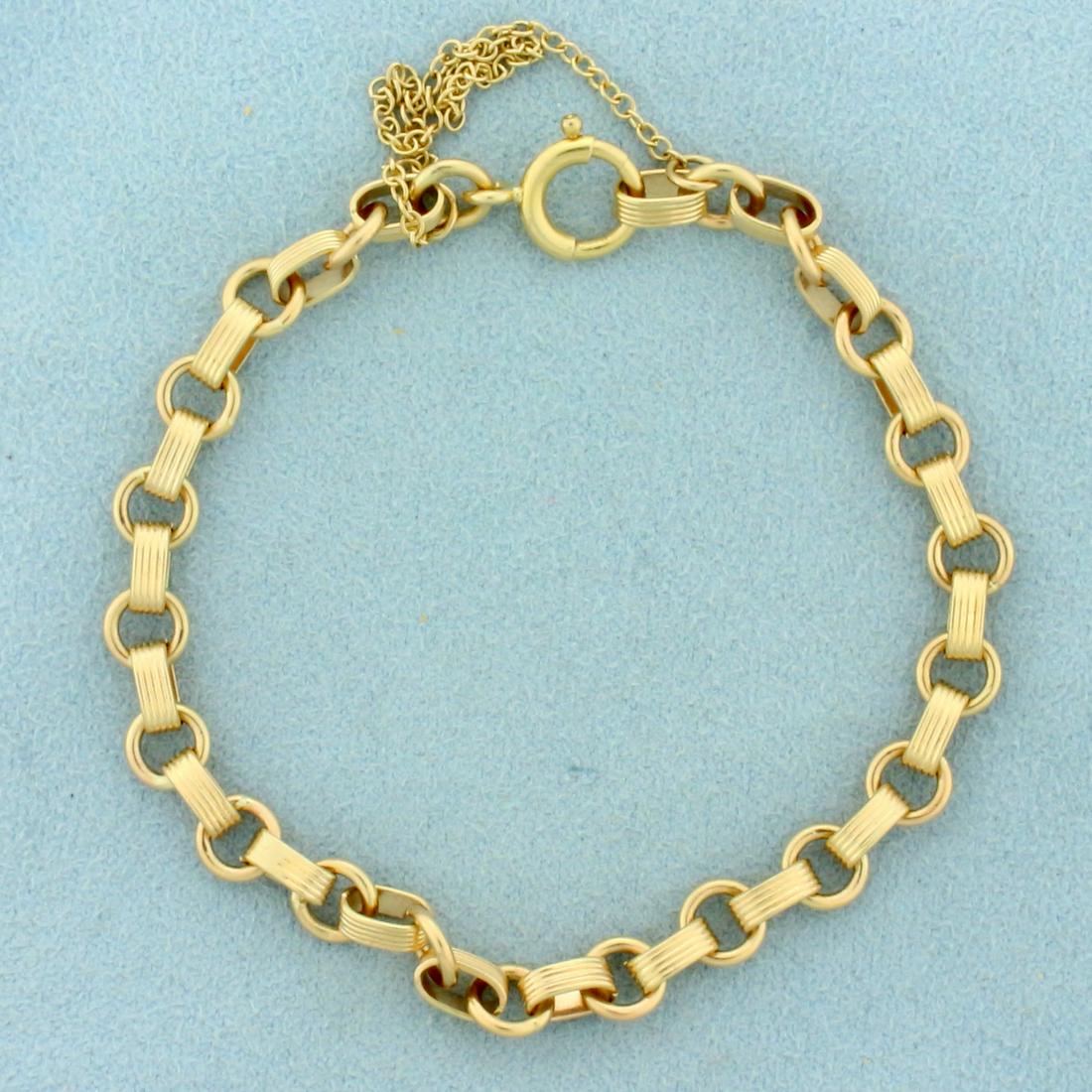 Designer Cable Link Bracelet in 14K Yellow Gold: In 14K Yellow Gold. 7 inches long, 5.8mm wide. Spring clasp and safety chain. 9.3g.