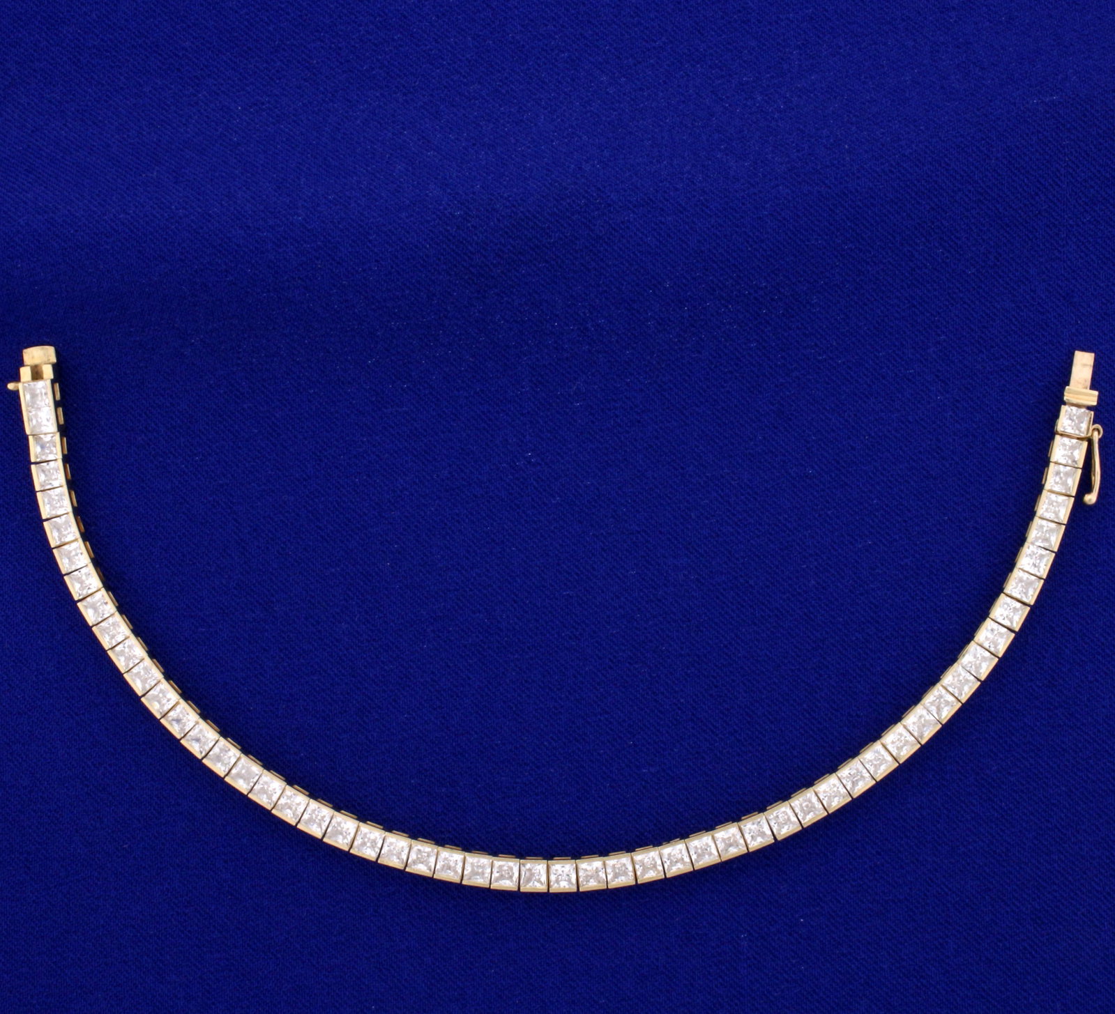 11ct TW Princess Cut CZ Line Bracelet in 14K Yellow: In 14K Yellow Gold. Contains fifty-five high quality 3.5mm princess cut CZ gemstones with excellent brilliance and lots of sparkle. With safety clasp. 7 1/4 inches long. 3.8mm wide. 11.5g