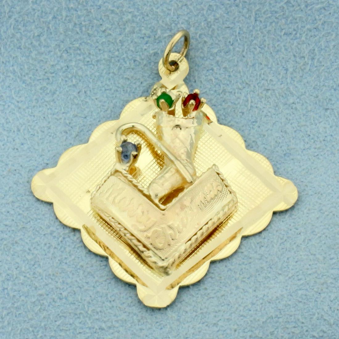 Merry Christmas Stocking and Candy Cane Pendant in 14K: In 14K Yellow Gold. 1 3/8 inches long with jump ring, 1 1/4 inches wide. Contains one high quality natural 2mm round Emerald, Ruby and Sapphire gemstones, all with bright color and excellent clarity.