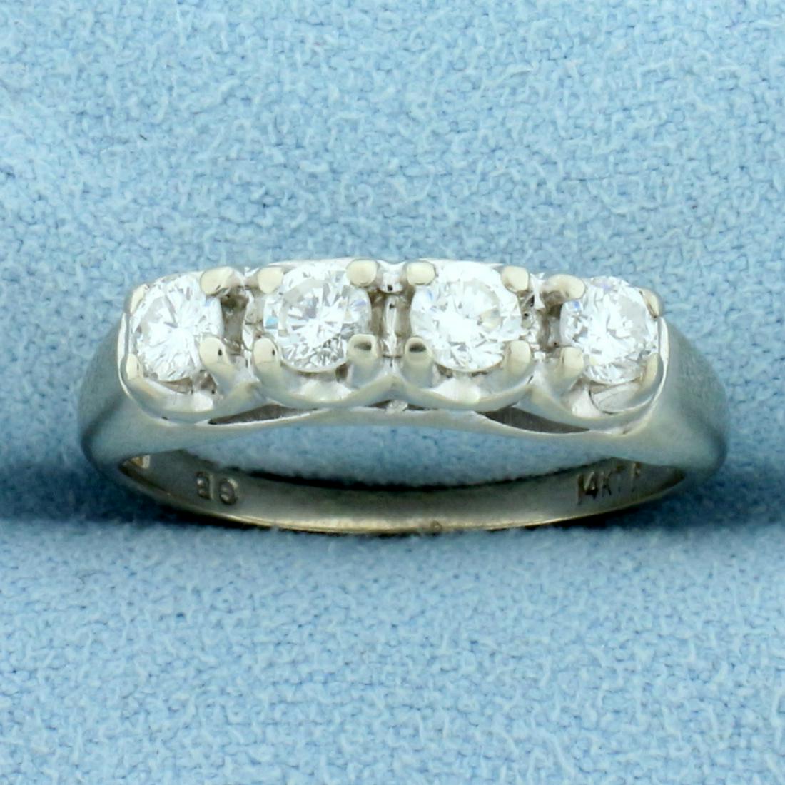 Four Stone Diamond Wedding or Anniversary Ring in 14K: In 14K White Gold. Contains four high quality 1/8ct round brilliant cut Diamonds, 1/2ct TW, SI clarity/G color. Size 6 1/2. 3.0g.