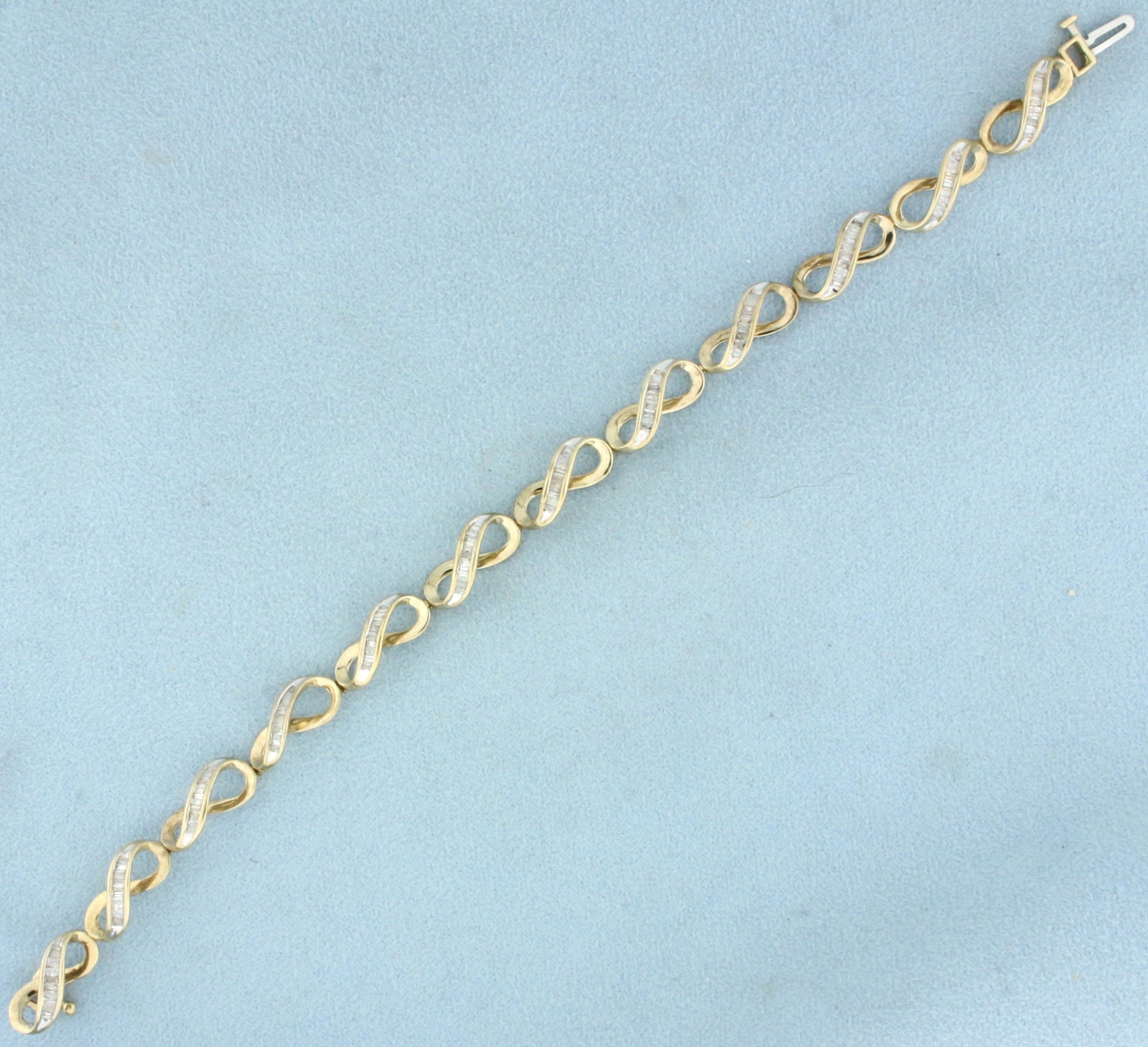 Baguette Diamond Bracelet in 10K Yellow Gold: In 10K Yellow Gold. Contains 1ct TW of baguette diamonds, I color/I clarity. 7 inches long. 7mm wide. 5.9g