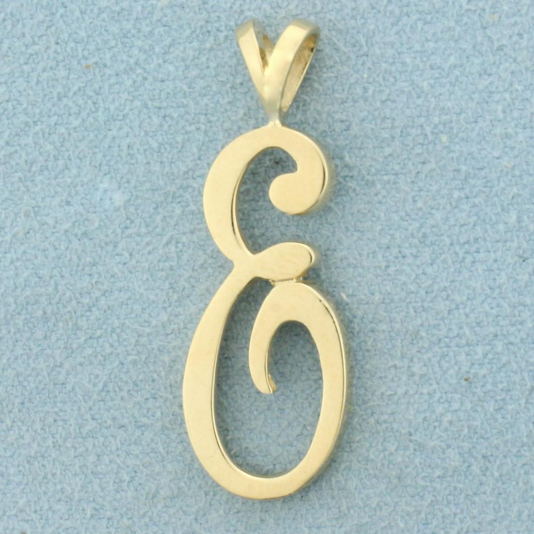 Initial E Pendant in 14K Yellow Gold: In 14K Yellow Gold. 1 3/8 inches long including bale, 1/2 inch wide. 2.5g.