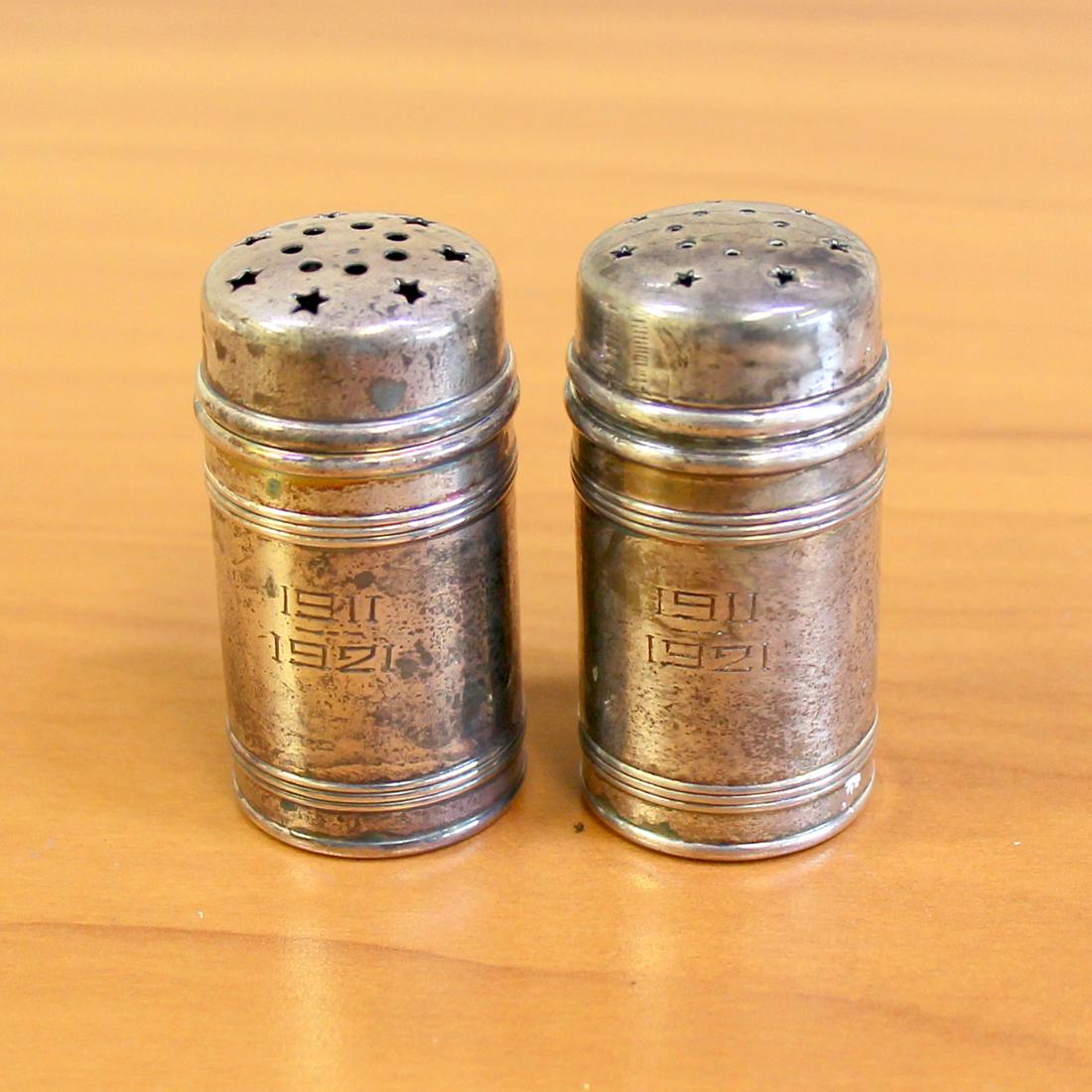 Antique Meriden Britannia Sterling Silver Salt & Pepper: In .925 sterling silver. Marked for Meriden Britannia, numbered as follows: 171-567, 158-567. Approx. 2-7/8" high with star cut outs on top. Engraved 1911 & 1921. 34g