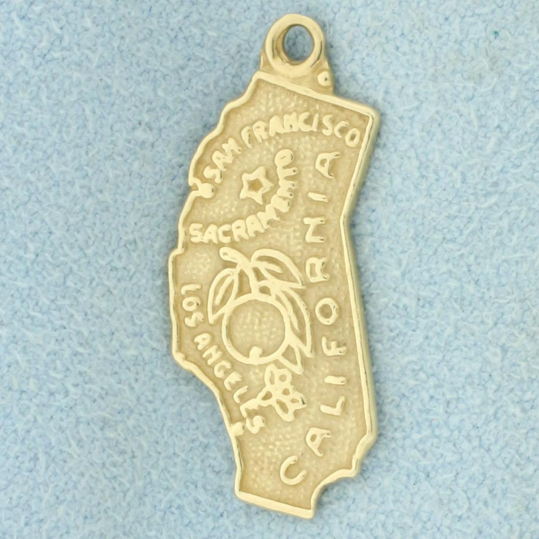 California State Charm in 14k Yellow Gold: In 14k yellow gold. 1 inch long, 3/8 inch wide. 1.7g