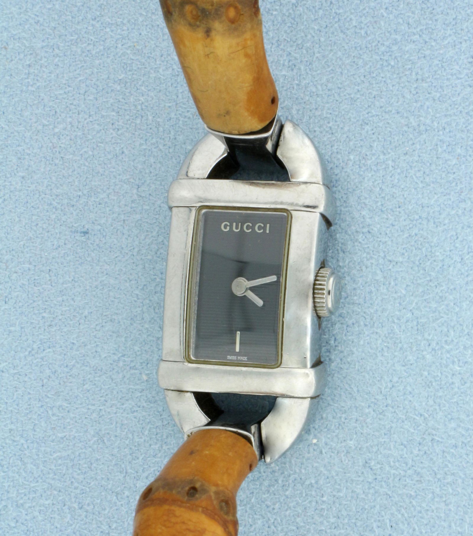 Vintage Gucci 6800L Bamboo Watch: Guaranteed authentic. Swiss movement runs great, with new battery. Stainless steel and bamboo (some wear on bamboo finish). 2 1/4 inch inner diameter. Case is 22mm by 16mm. 32.8g