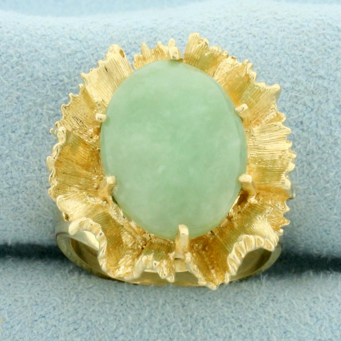 7ct Jade Statement Ring in 14K Yellow Gold: In 14K Yellow Gold. Contains one high quality natural 16 x 12mm oval cut Jade gemstone with uniform bright green color and excellent clarity. Size 6 1/2. 8.0g.