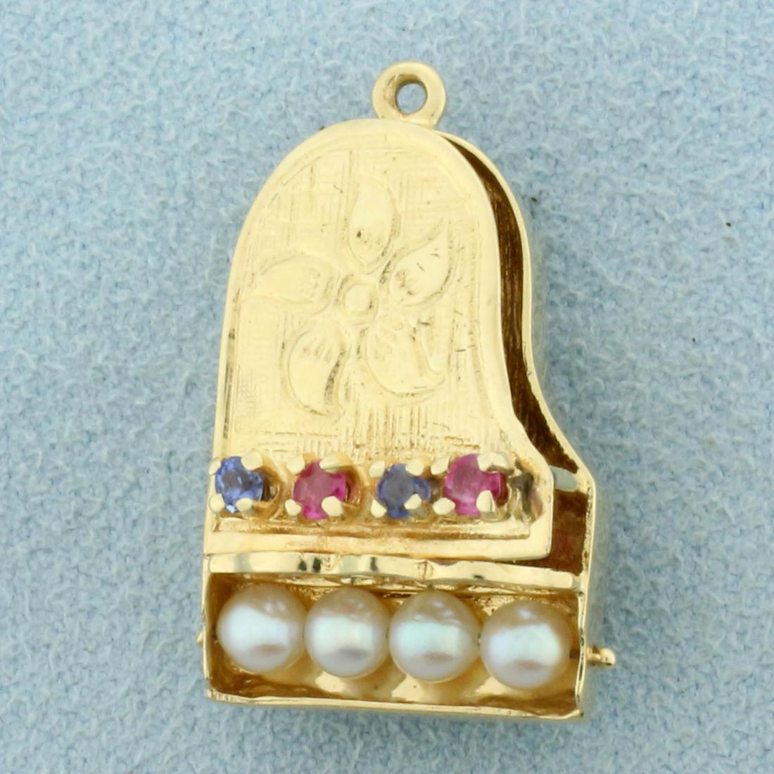 Grand Piano Charm or Pendant in 14K Yellow Gold: In 14K Yellow Gold. Contains two high quality natural 2mm Sapphire and Ruby gemstones with bright color and excellent clarity. Also contains seven 3.4mm cultured Pearls with high luster. 1 inch long i
