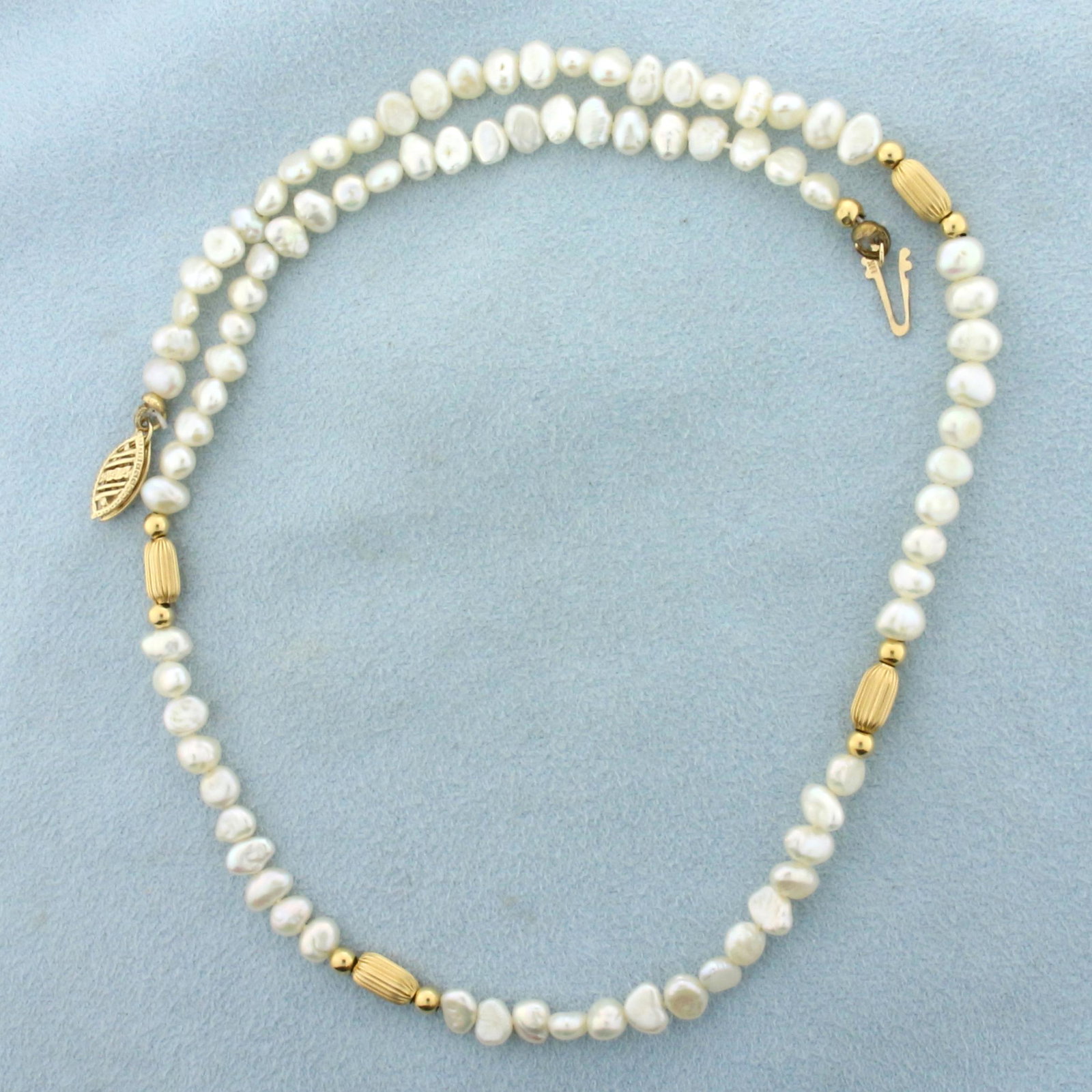 Baroque Pearl and Gold Bead Choker Necklace in 14k Yellow Gold: In 14k yellow gold. Contains 82 high quality natural 5mm baroque freshwater pearls with high luster. 16 inches long. Also contains 12 gold beads. Fishhook clasp. 8.3g