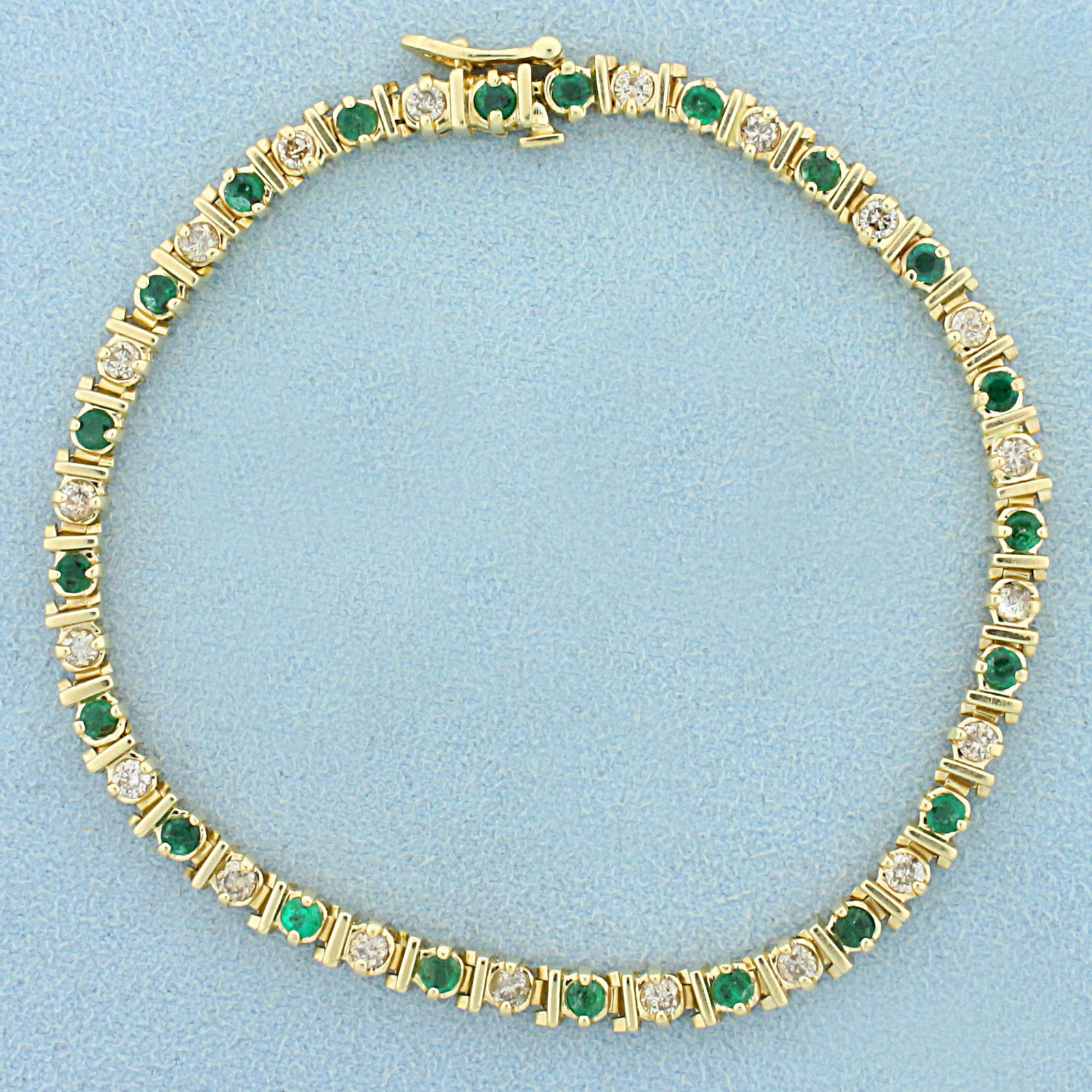 Natural Emerald and Champagne Diamond Bracelet in 14K Yellow Gold: In 14K Yellow Gold. Contains twenty one high quality natural 2.5mm Emerald gemstones with bright green color. Also contains twenty high quality .05ct Champagne Diamonds with warm champagne color that 