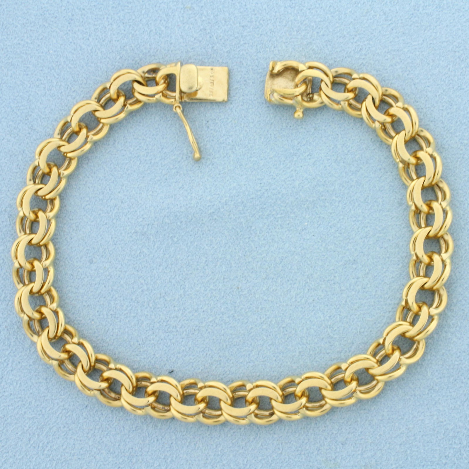 Cable Link Charm Bracelet in 14k Yellow Gold: 14k yellow gold. 7 3/4 inches long, 7.7mm wide. Safety clasp. 23.3g.