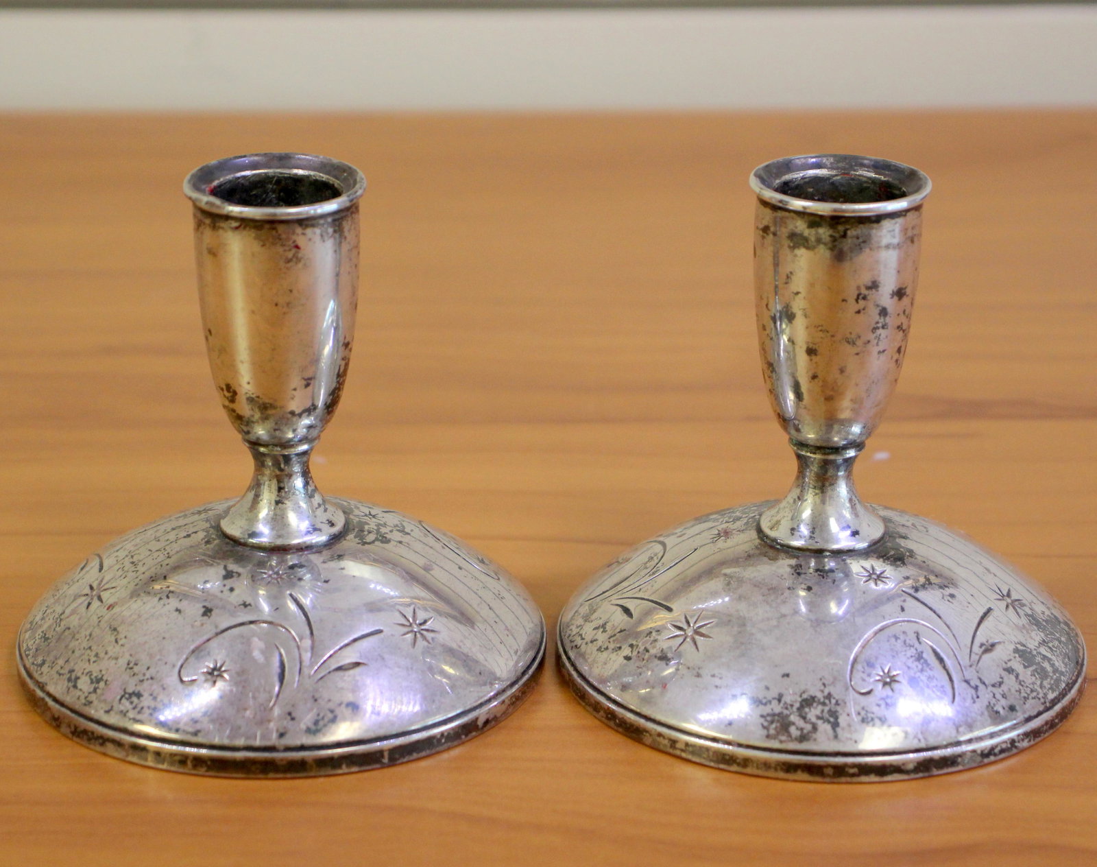 Gorham Star Design Sterling Silver Candlesticks: In Sterling Silver, weighted. Set of candlesticks with shooting star designs on the base. 4 inches high, 3 3/4 inches wide. 676.1g.