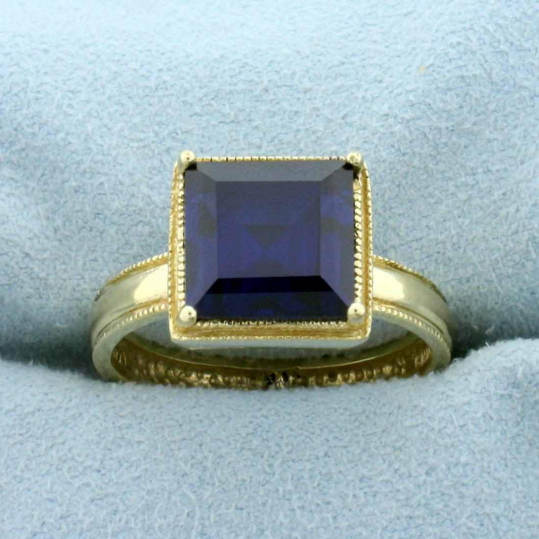 6ct Lab Sapphire Solitaire Ring in 14k Yellow Gold: In 14k Yellow Gold. Contains one high quality 10mm Lab Sapphire gemstone with perfect velvet blue color and excellent clarity. Size 9. 6.8g.