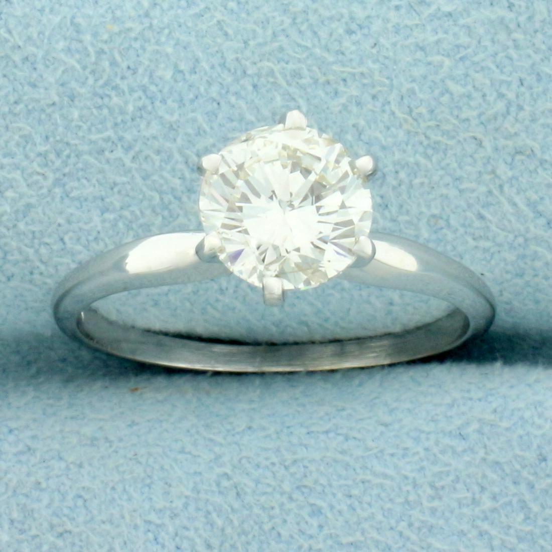 1.5ct Solitaire Diamond Engagement Ring in 18k White Gold: 18k White Gold. Contains a 1.5ct Round Brilliant Diamond, J Color/SI Clarity, completely eye clean and great cut for lots of sparkle. Faces up very "white". Size 7.5. 2.7g.