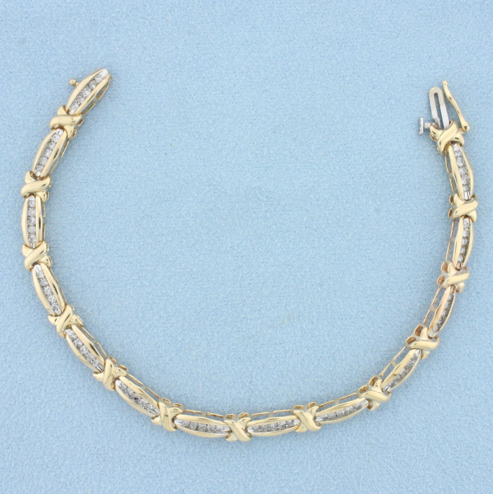 1ct Channel Set Diamond Tennis Bracelet in 10k Yellow Gold: In 10k yellow gold. Contains 65 high quality diamonds, 1ct TW, I color/I clarity. Concealed clasp with safety latch. 6 5/8 inch long. 8.6g.