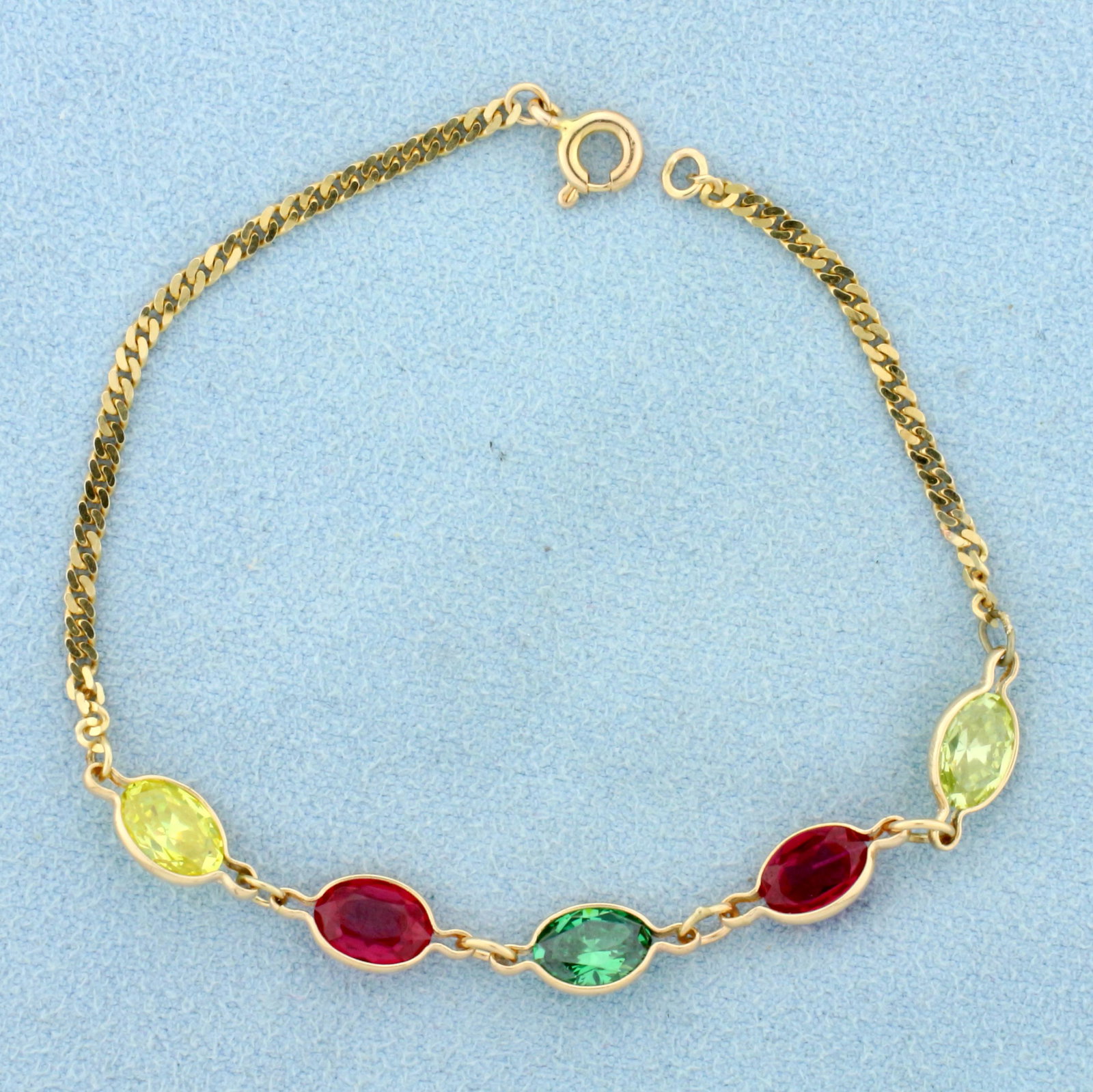 Multi-Colored Topaz Bracelet in 14K Yellow Gold: In 14K Yellow Gold. Contains five high quality 6 x 5.5mm oval cut Topaz gemstones in red, green, and yellow vibrant colors with excellent clarity. Spring clasp. 6 1/2 inches long. 2.9g