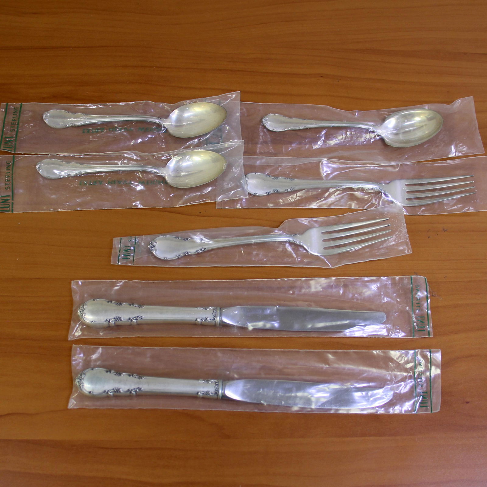 Lunt Modern Victorian 7 Piece Flatware Set in Sterling Silver: In sterling silver. In original sealed wrappers in excellent condition. Set includes two teaspoons - 6 inches long, two forks - 7.25 inches long, two knives - 5 7/8 inches long, and one sugar shell sp