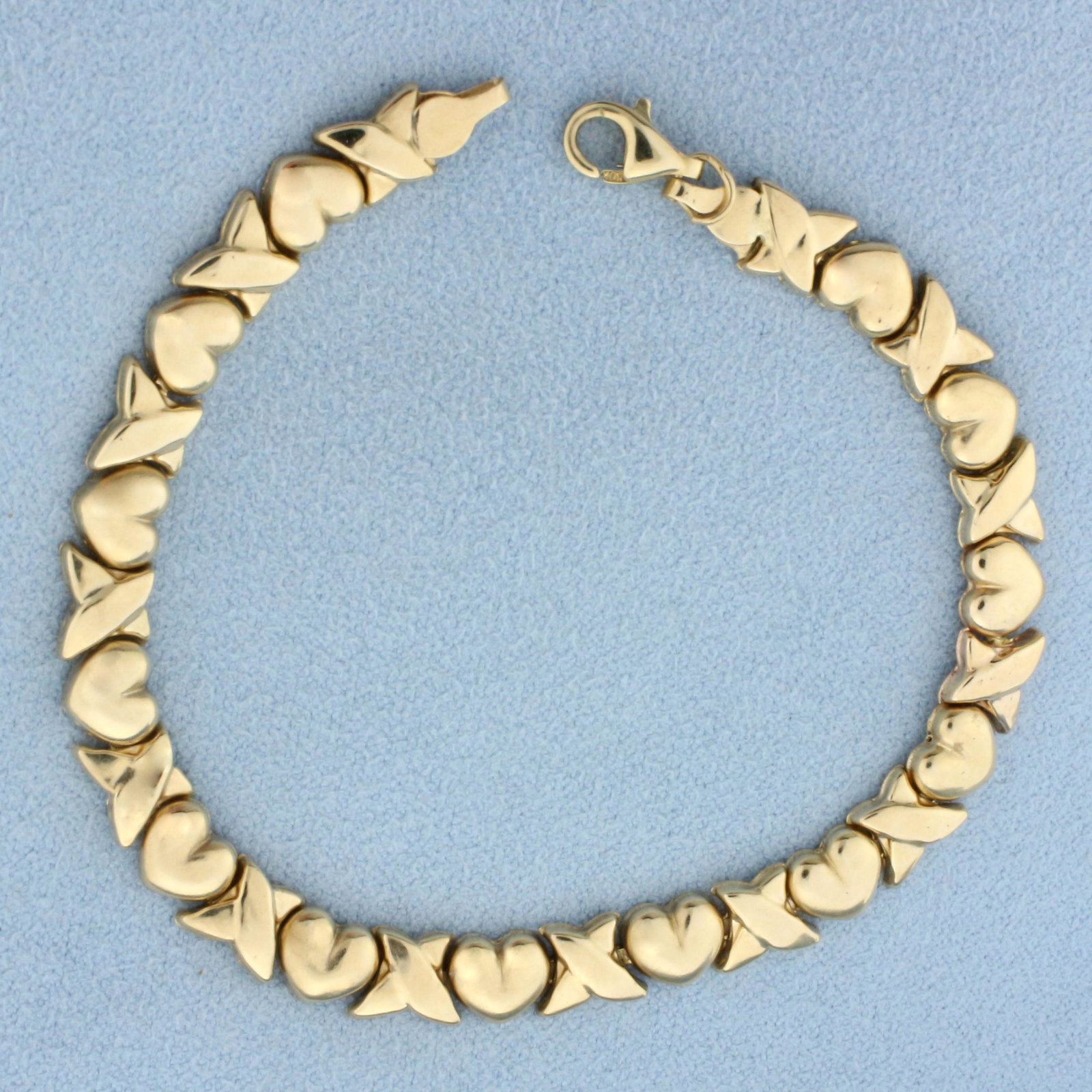 Heart Link Bracelet in 10k Yellow Gold: In 10k yellow gold. In good condition with minor indents as shown in photo. Measures 7 1/8 inch long and 6mm wide. lobster clasp. 4.0g.