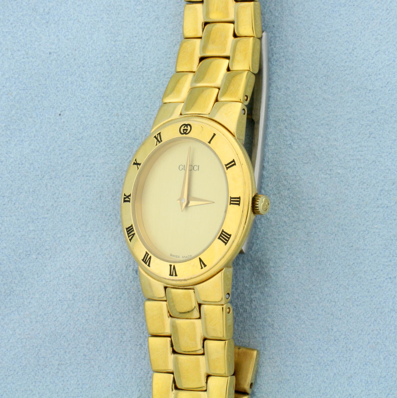 Gucci Ladies 3300.2L Watch: 18k Gold Plated Watch. Swiss made quartz movement runs great. New battery. Great condition with minor wear for age. Light, small scratch on crystal, not noticeable. 26mm case. 48.3g.