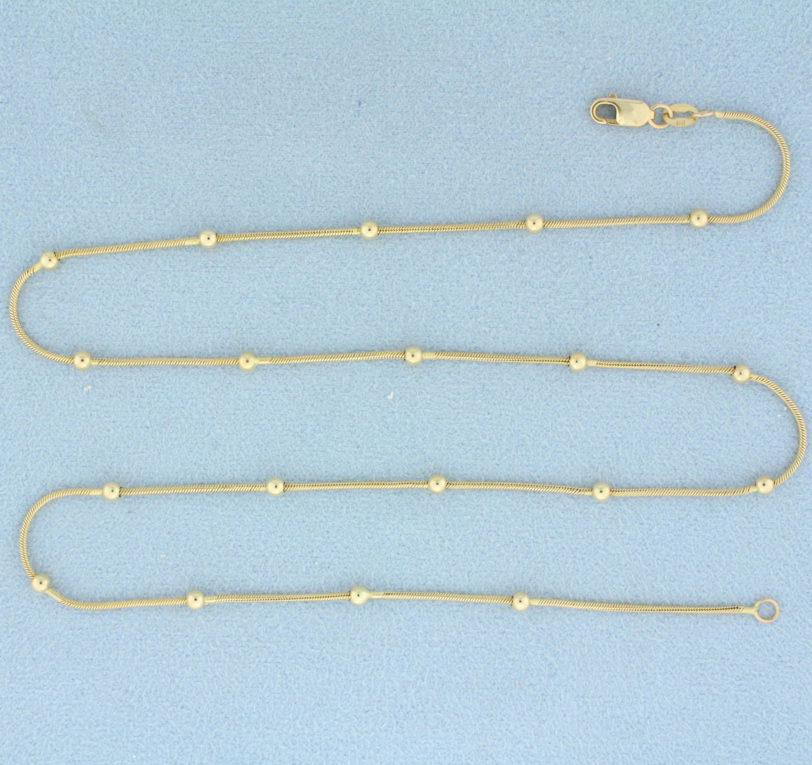 Italian 17 inch Snake Link Bead Station Necklace In 14k Yellow Gold: In 14k yellow gold. Italian Made. Measures 17 inches long and 1mm wide with 2.5mm beads. Lobster clasp. 4.0g.