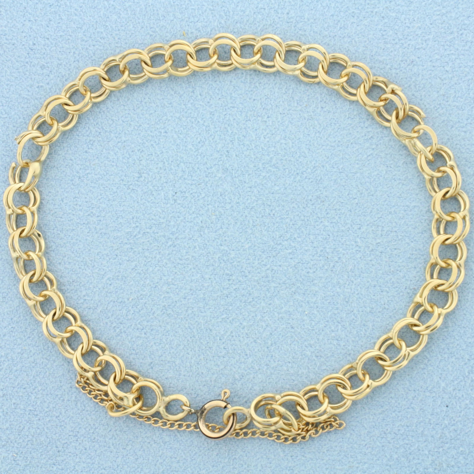 Cable Link Charm Bracelet in 14k Yellow Gold: 14k yellow gold. 7 1/4Inches long, 5.5mm wide double cable link. Safety chain. 7.1g.