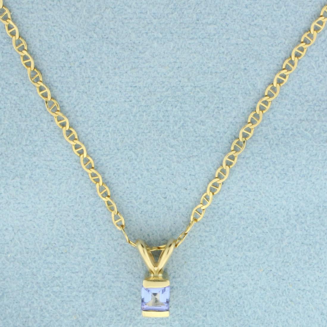 Tanzanite Necklace in 14K Yellow Gold: In 14K Yellow Gold. Contains one high quality natural 1/4ct Tanzanite gemstone with vibrant color and excellent clarity. Chain is 17 inches long, 1.7mm wide; anchor link. Pendant is 3/8 inch long incl