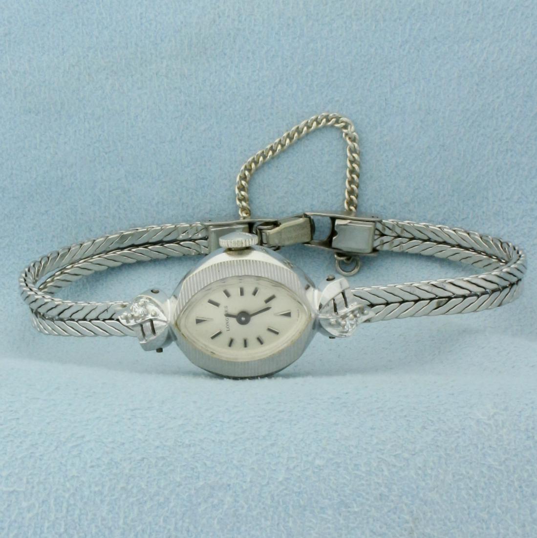 Vintage Womens Windup Longines Diamond Wrist Watch in Solid 14K White Gold Case: Solid 14k White Gold Case, Band is gold filled. Windup movement runs great, just serviced. Watch in overall great condition, no scratching on crystal and very minimal scratching on band. Contains two 