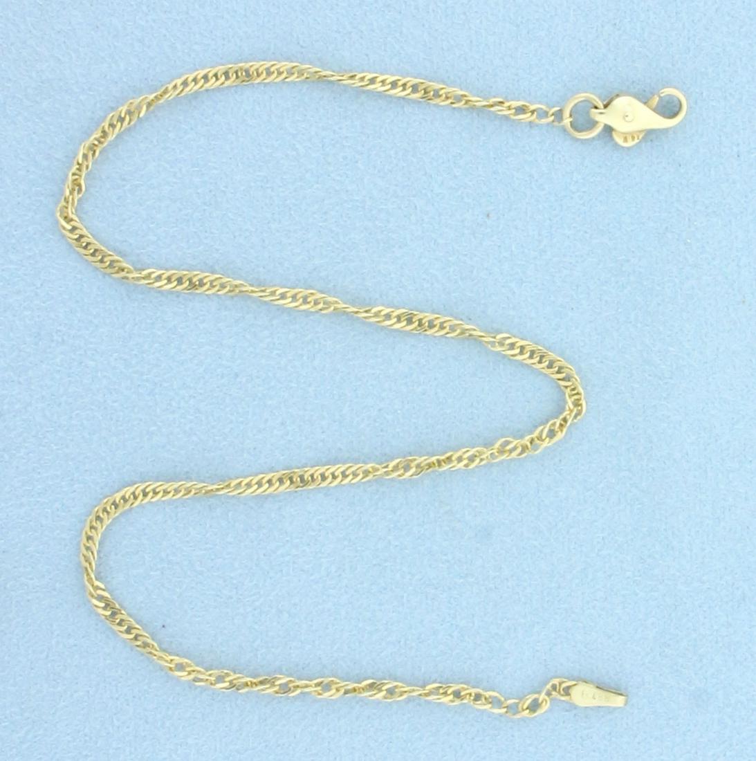 10.5 Inch Twisting Curb Link Anklet In 14k Yellow Gold: 14k Yellow Gold. 10.5 inches long, 2.30mm wide. Lobster clasp. 3.1g.