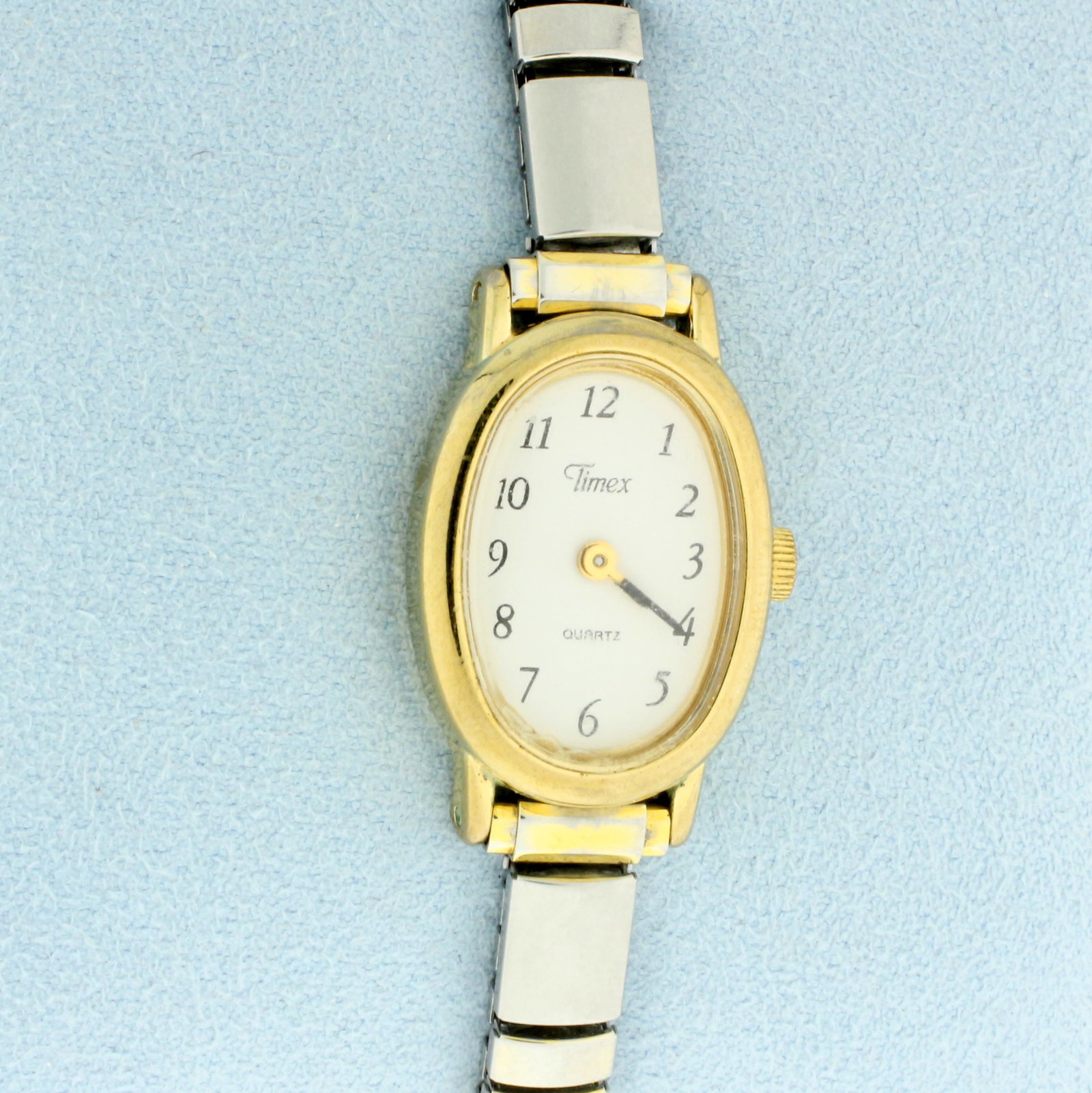 Vintage Womens Timex Quartz Watch in stainless steel: In gold plated stainless steel. Quartz movement runs great, new battery. Gold tone case with silvertone stretch band. Case is 24mm long.