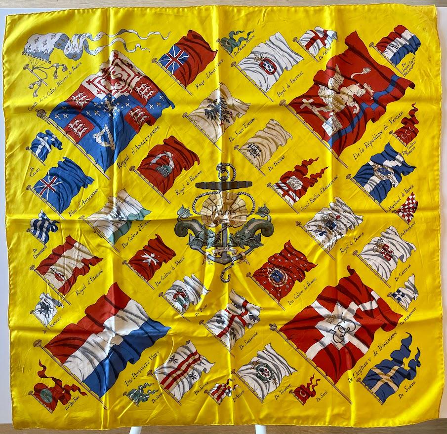 Hermes Pavois Carre 90 Flag Medieval Silk Scarf: Guaranteed authentic with original box. Hermes 35" x 35" (90cm) vintage scarf. Made in France, 100% silk, hand rolled edges. Created by famed artist Philippe Ledoux with vibrant yellow backdrop and fl