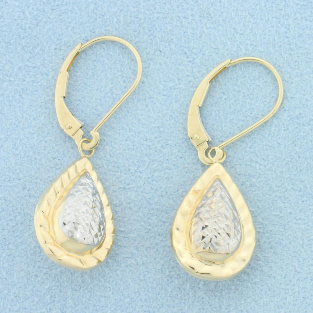 Dangle Drop Teardrop Shaped Earrings in 14k Gold: 14k yellow and white gold. 1 1/4 Inch long, 3/8 Inch wide. Lever back closures for pierced ears. 1.9g.
