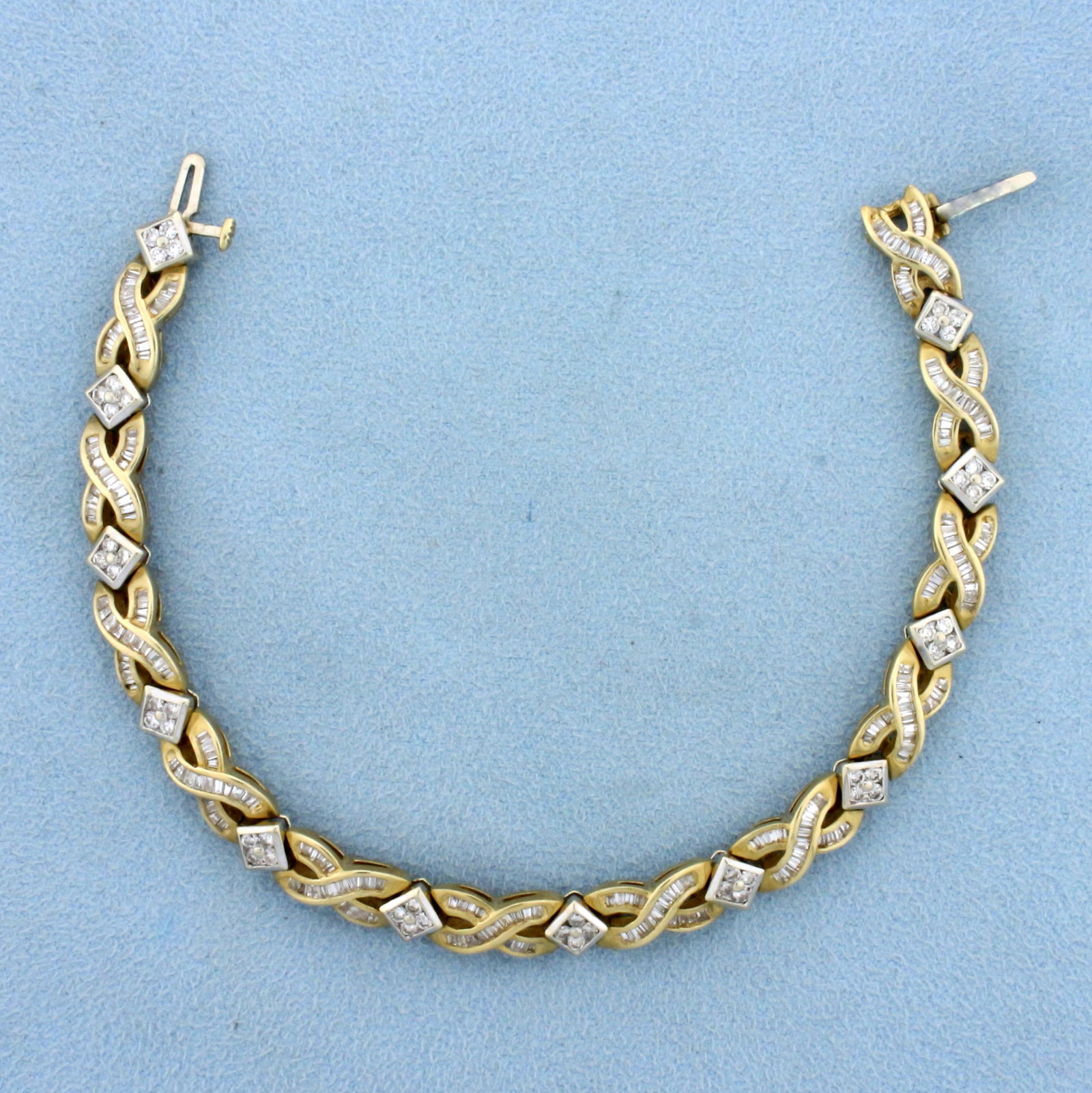 3ct TW Baguette and Round Diamond Bracelet In 14K Yellow and White Gold: In 14k yellow and white gold. Contains 1/2 ct TW of high quality round brilliant diamonds, SI clarity/H color. Also contains 2 1/2 cts of baguette diamonds of similar high quality. 6.4mm wide. 7 inche
