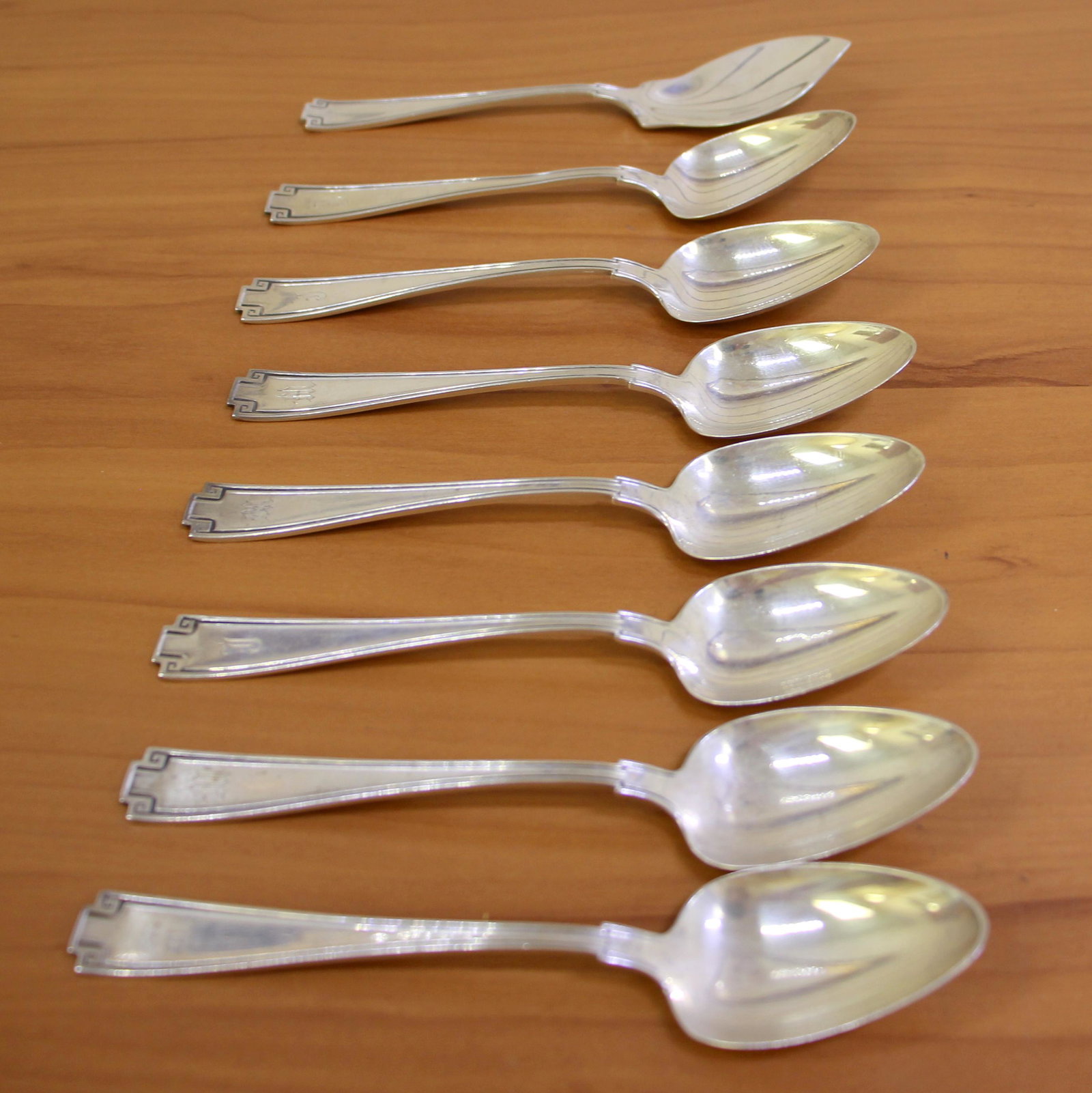 Gorham Etruscan Sterling Silver Teaspoons and Jelly Server Set: In .925 sterling silver. Seven teaspoons- 5 3/4 inches (monograms as shown) One jelly server- 5 5/8 inches (no monogram). 167.7g.
