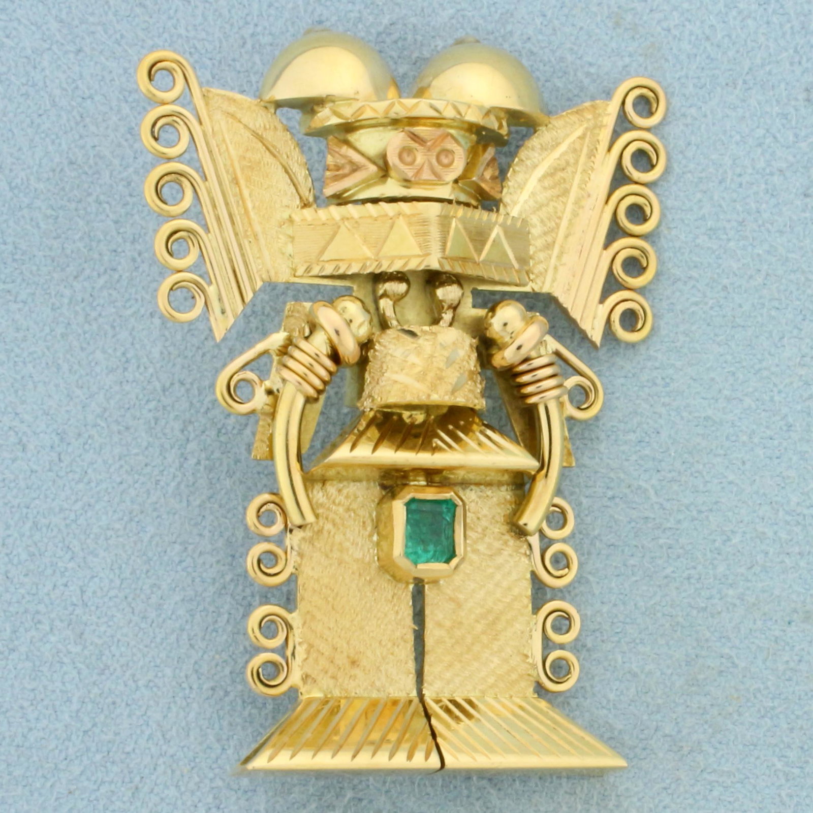 Aztec or Inca God Emerald Pendant or Brooch in 18k Yellow Gold: In 18k yellow gold with 18k rose gold accents. Contains one high quality emerald cut .40ct Emerald gemstone with excellent clarity and vibrant emerald green color. Expertly crafted metalwork. Can be w