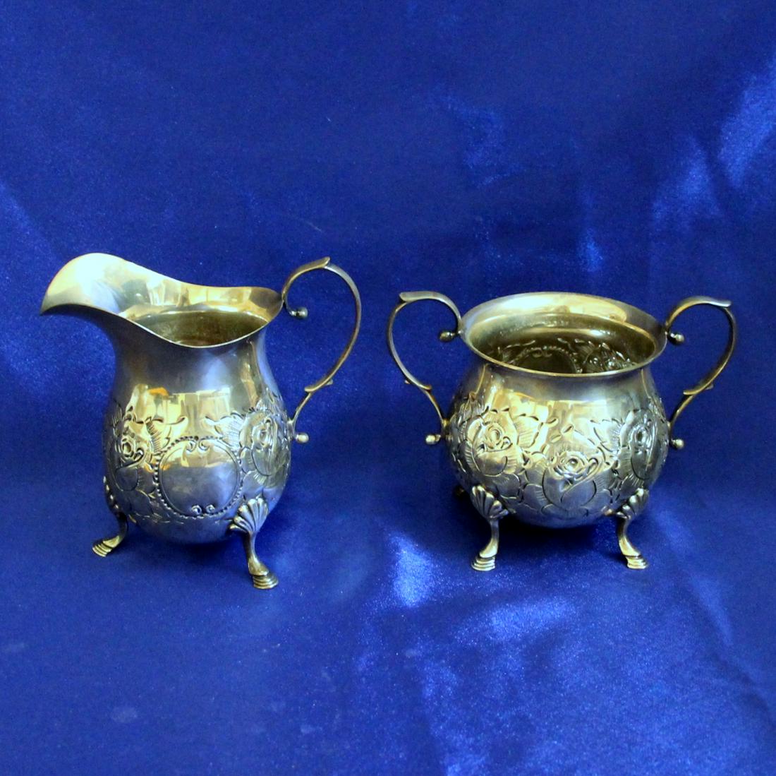 Antique B&M Hand Chased Creamer and Sugar Bowl in Sterling Silver: Solid .925 Sterling Silver. 1 Sugar Bowl - 3 3/4 inches tall, stamped D25. 1 Creamer - 4 1/2 inches tall, stamped D25. Amazing detail. Great condition. 343.3g