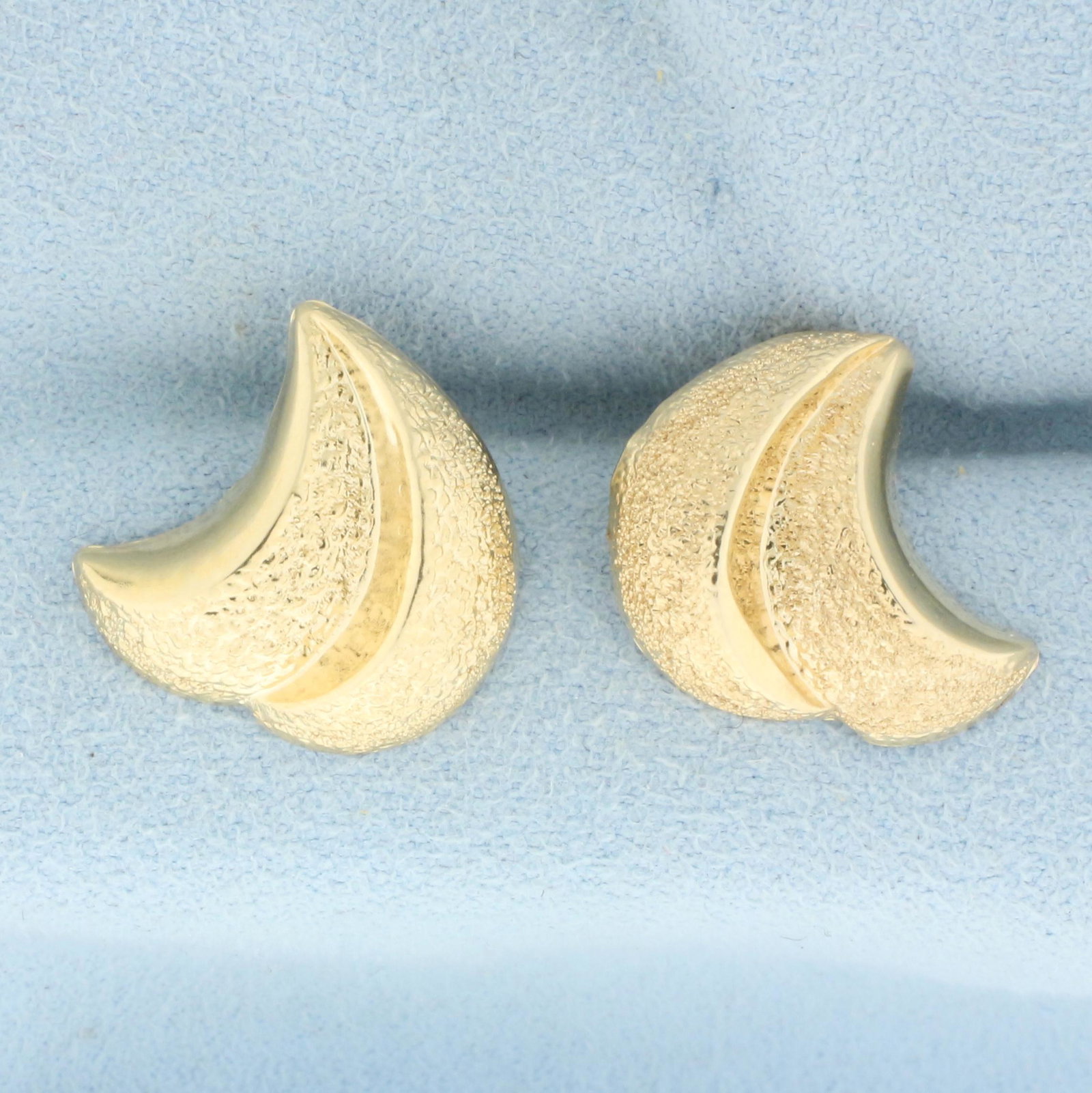Sand Blasted Wave Design Earrings in 14k Yellow Gold: In 14k yellow gold. Sand blasted on the front of earrings.5/8 inches long, 1/2 inch wide. Friction backs. 1.0g.