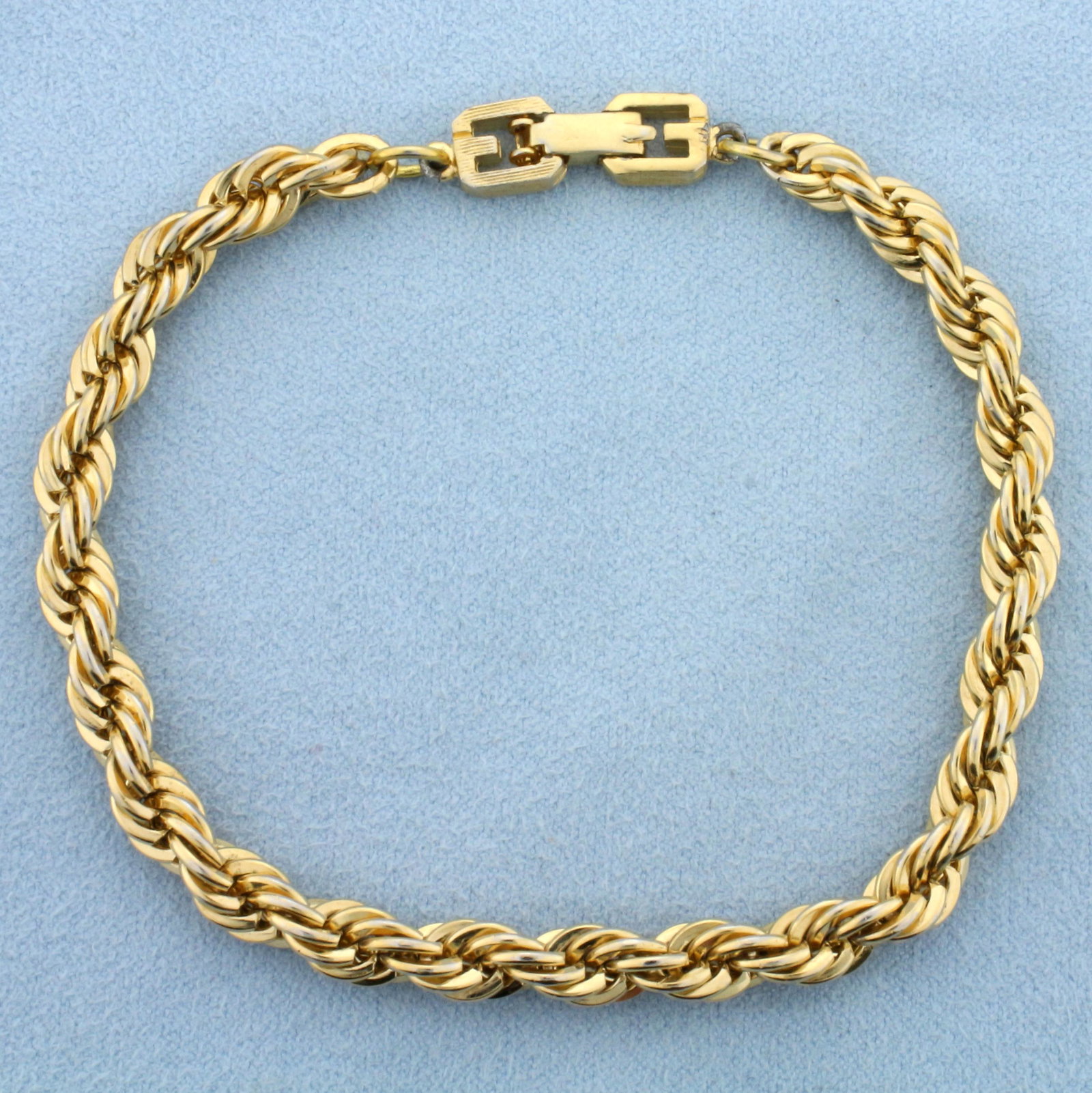 Vintage Givenchy Designer Signed Chunky Double G Rope Chain Bracelet: Gold plated. Circa 1980-1990s. 6mm wide and 8.5' inches long. Iconic double G logo closure. Chunky classic rope style.
