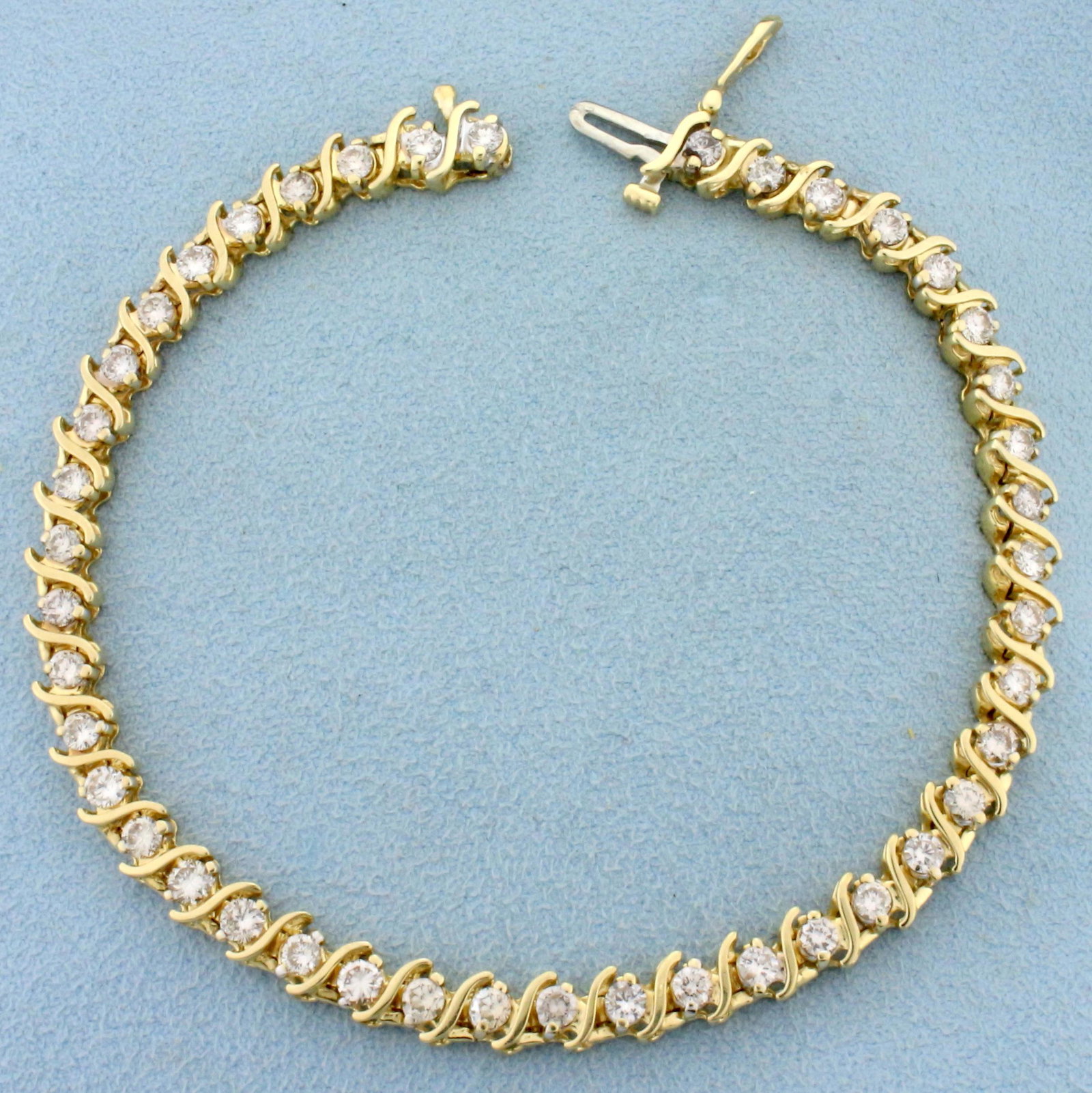 4ct TW Diamond Tennis Bracelet in 14K Yellow Gold: In 14K Yellow Gold. Contains forty three high quality Diamonds, 4ct TW, SI2 clarity/I color. 8 inches long. 14.3g.