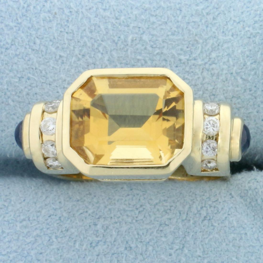 Citrine Sapphire and Diamond Ring in 14k Yellow Gold: In 14k yellow gold. Contains one high quality emerald cut citrine gemstone, 11x9mm, 4.5ct with vibrant golden yellow color and excellent clarity. Also contains two 3.5mm cabochon cut high quality natu